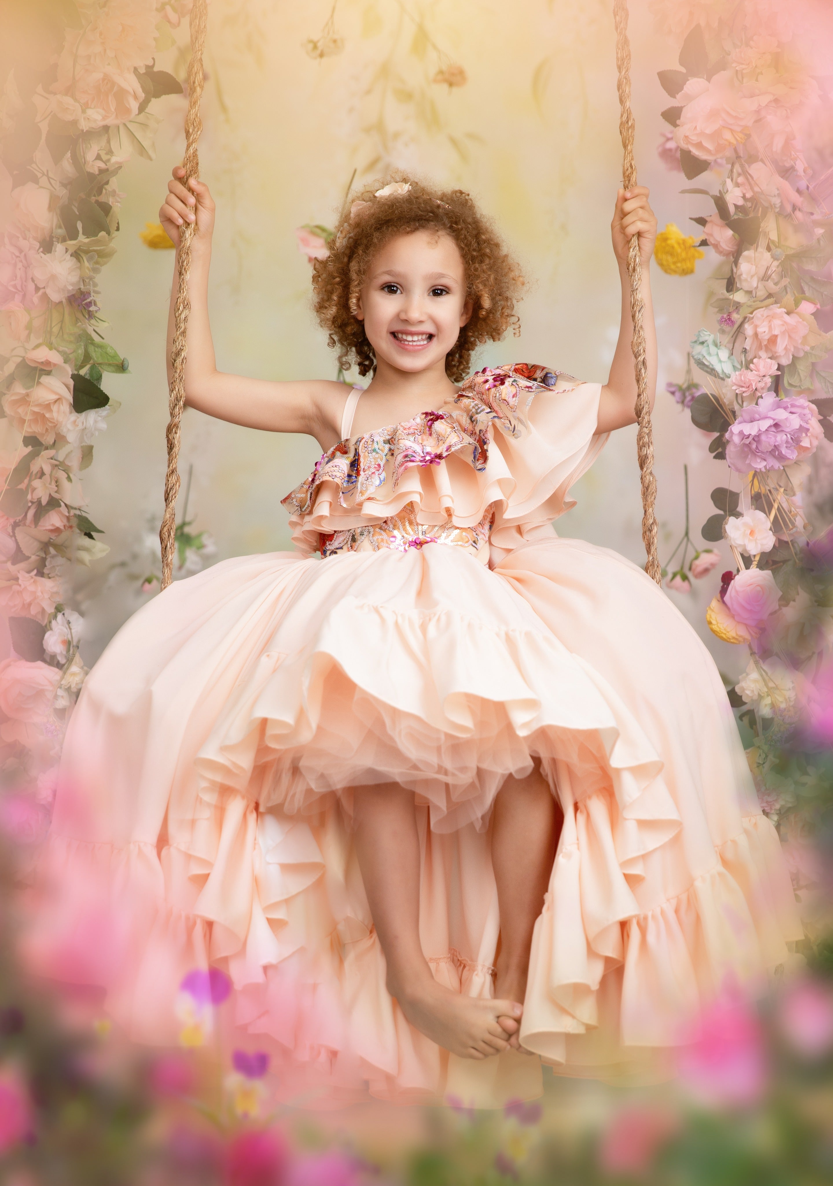 little girl swinging and wearing a spring couture gown