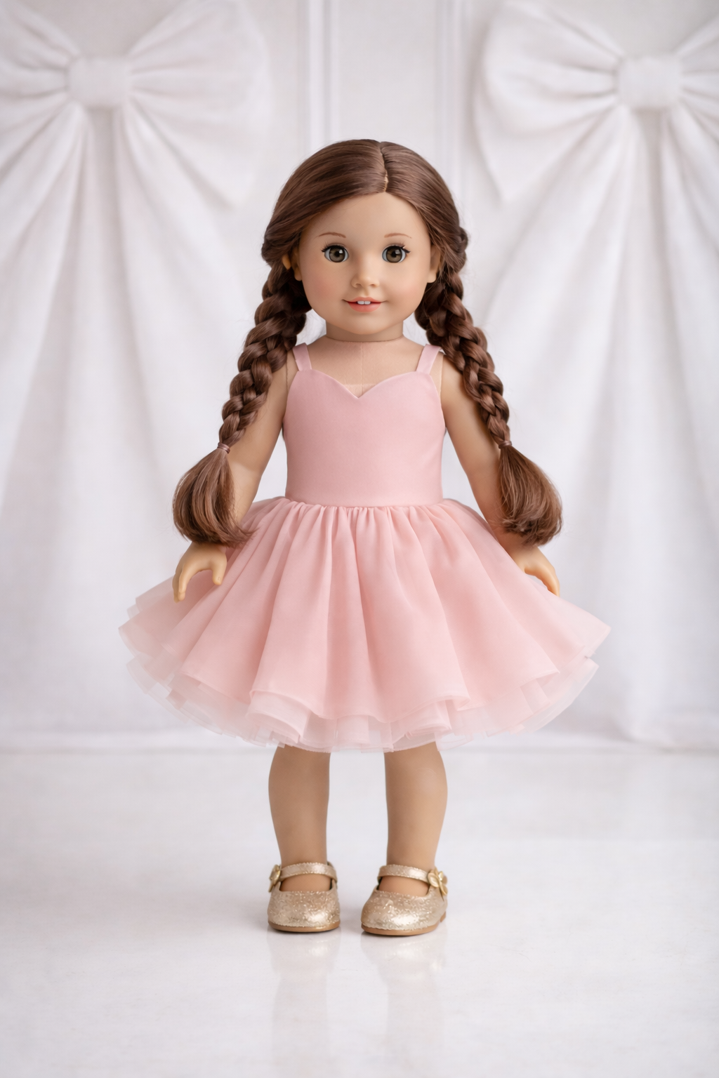 Doll wearing a pink dress with a white background