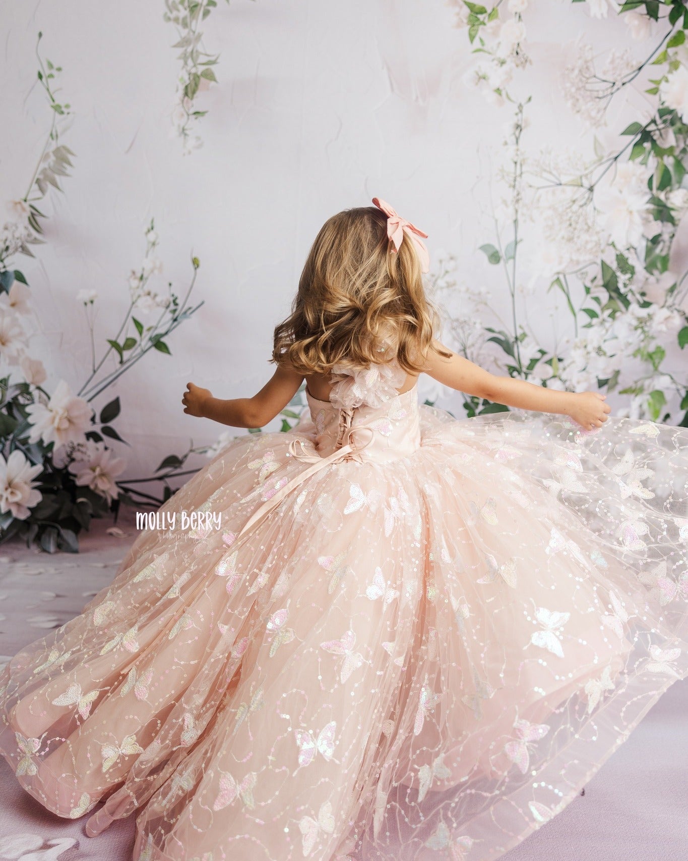 "Back view of the Anastasia gown, showcasing the adjustable shoulder ties and flexible elastic back for a perfect fit."