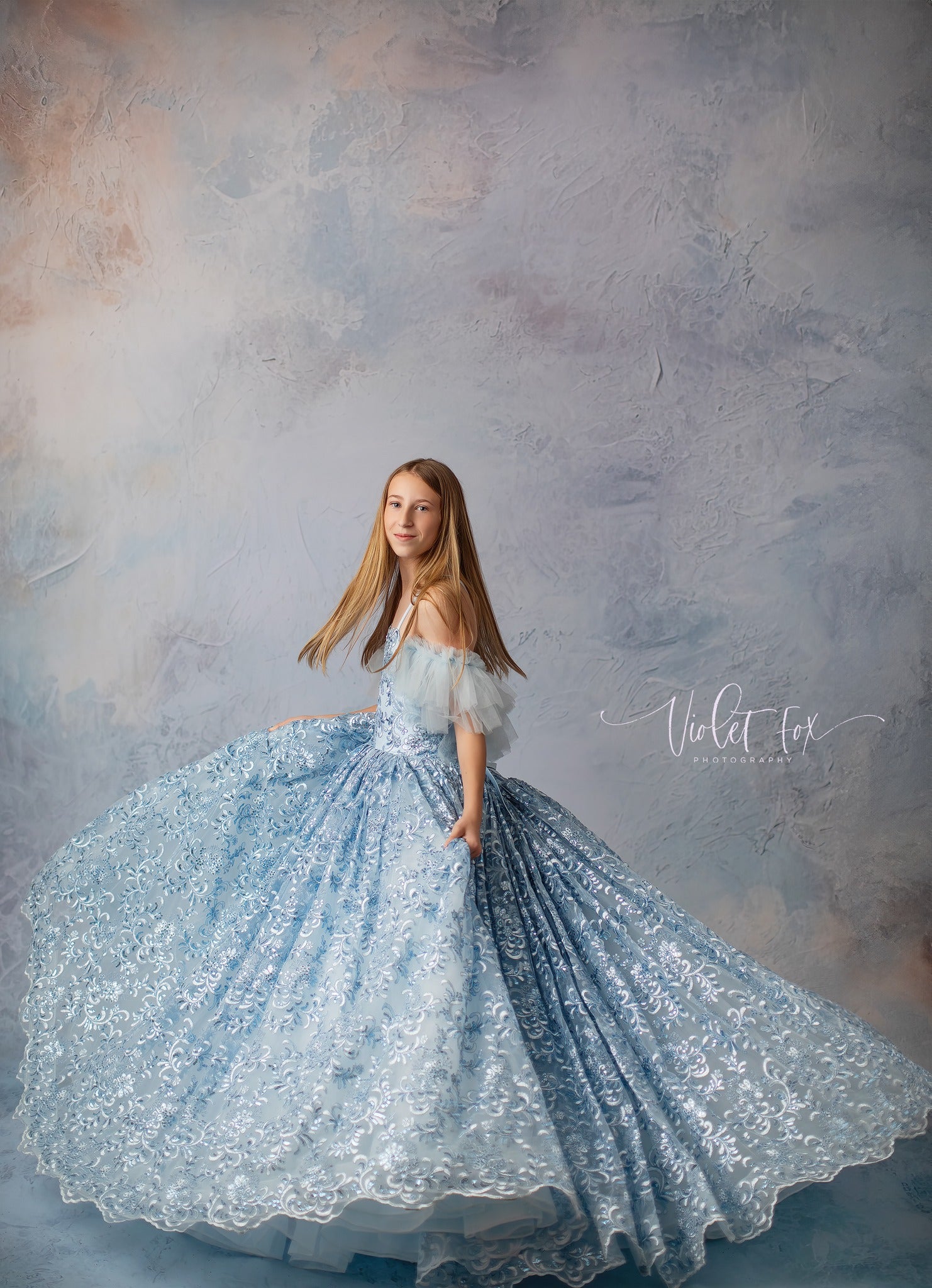 "Cinderella-inspired gown with layers of soft tulle and a glittering bodice, perfect for a whimsical photoshoot."