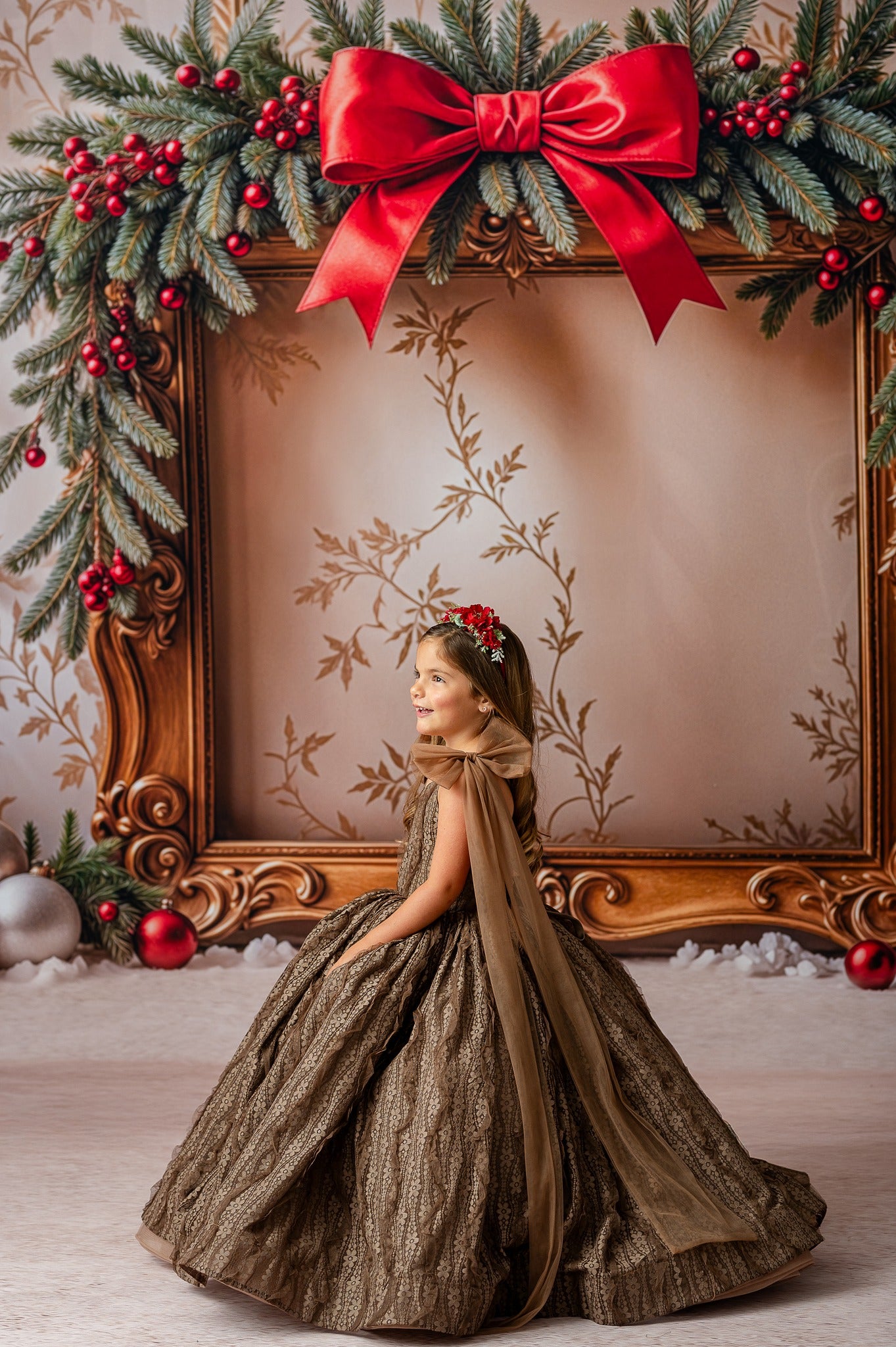 "Young girl wearing a couture gown made of elegant jacquard fabric with oversized removable tulle bows on the shoulders."