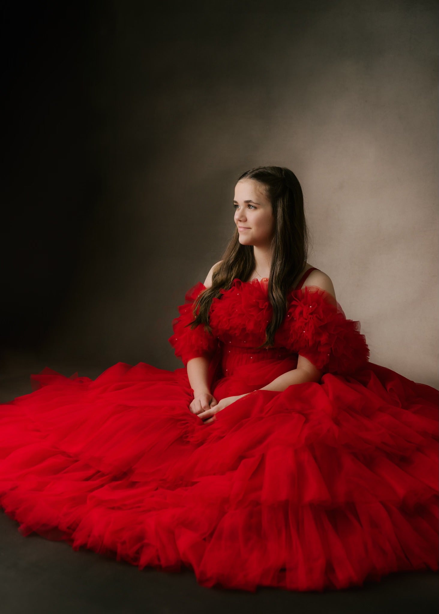 "Custom floor-length gown with voluminous layers of bridal tulle and adjustable straps"