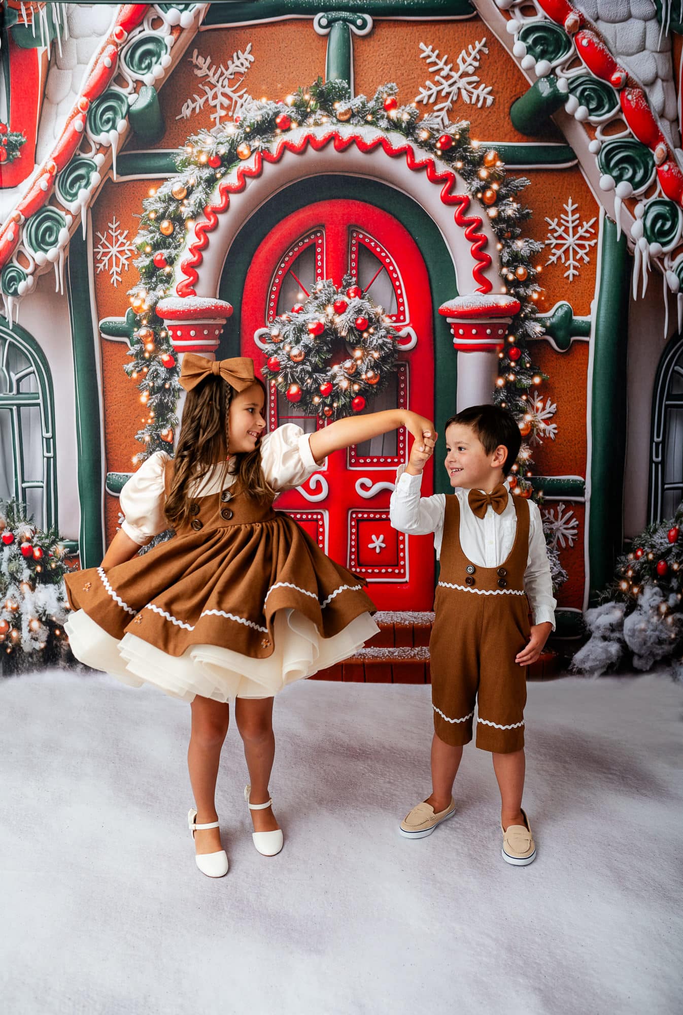 siblings wearing matching gingerbread outfits