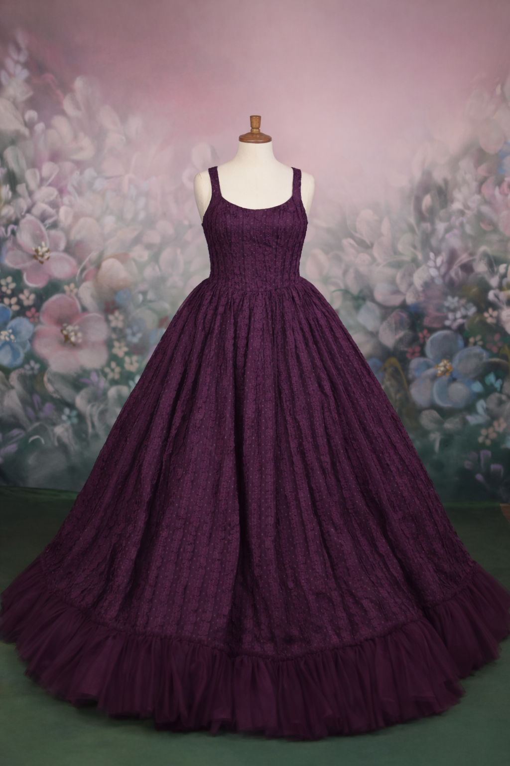 Purple ball gown on a mannequin against a floral background