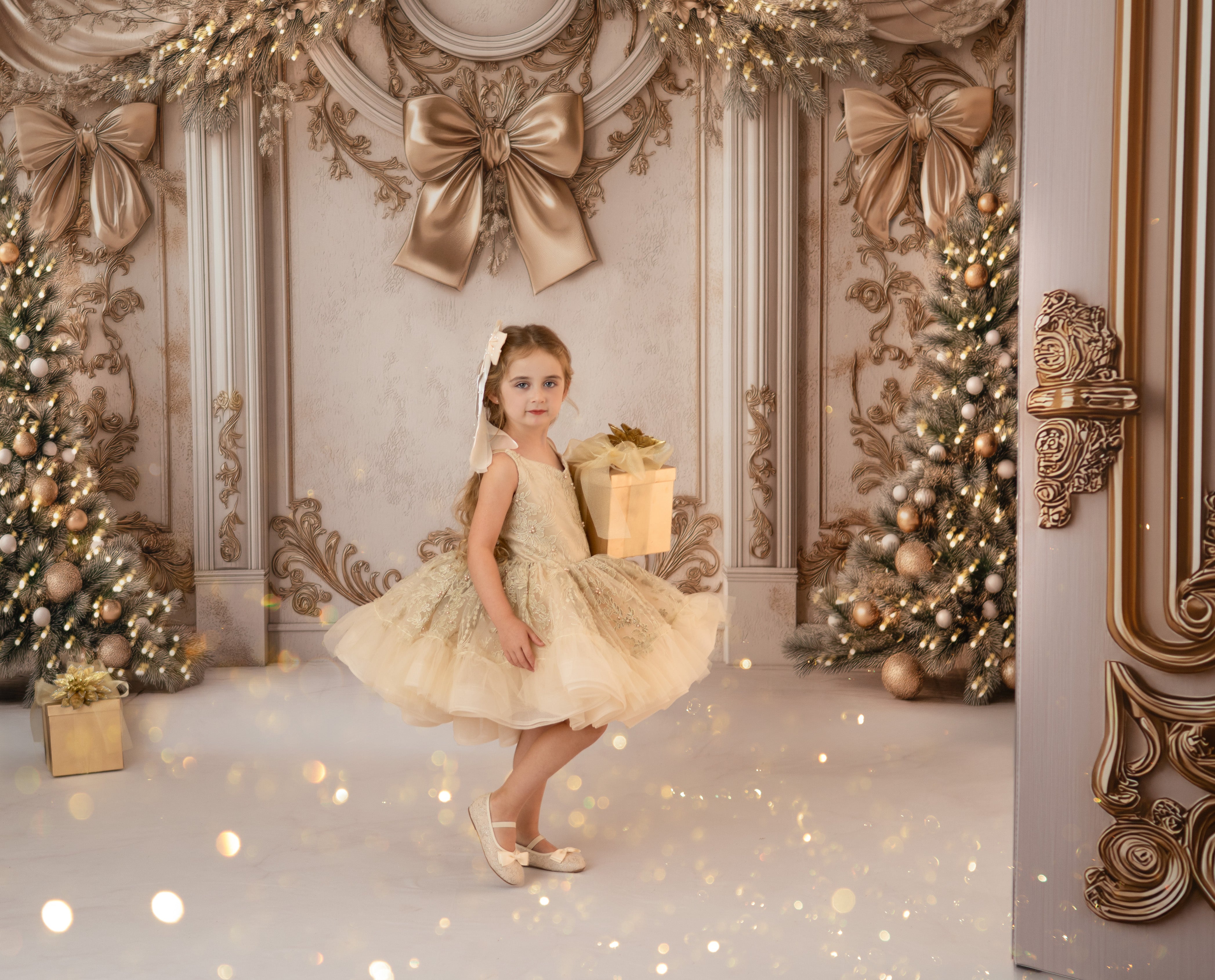Young girl in a festive setting with decorated trees and gold bows.