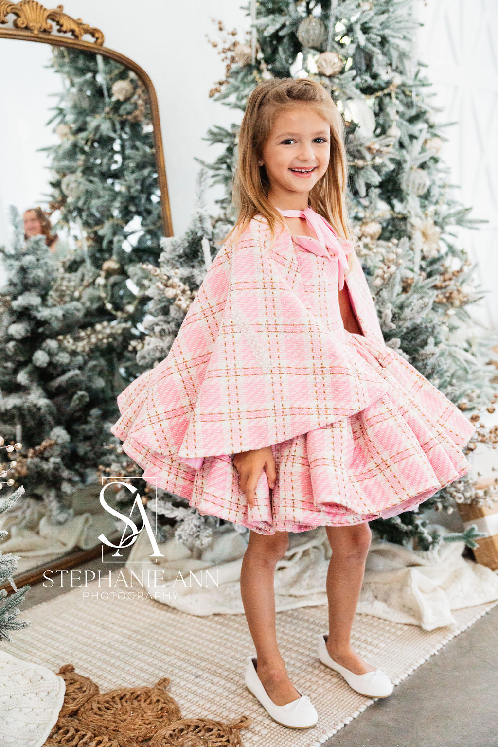 Girl wearing a beautiful pink wool plaid dress with long sleeves and a vintage vibe.