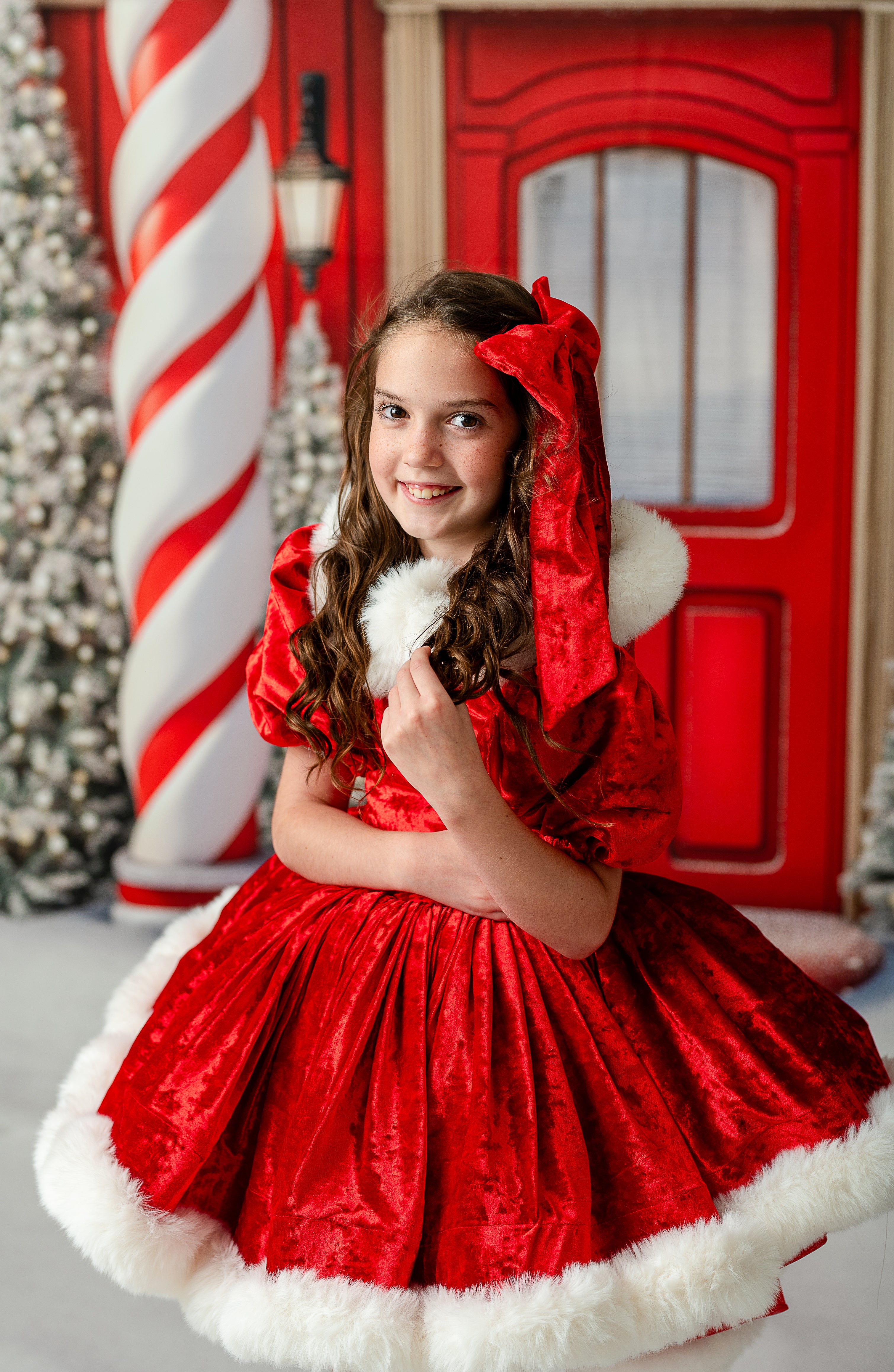 Holiday fine art session with girl dressed in full Mrs. Claus & Co. set