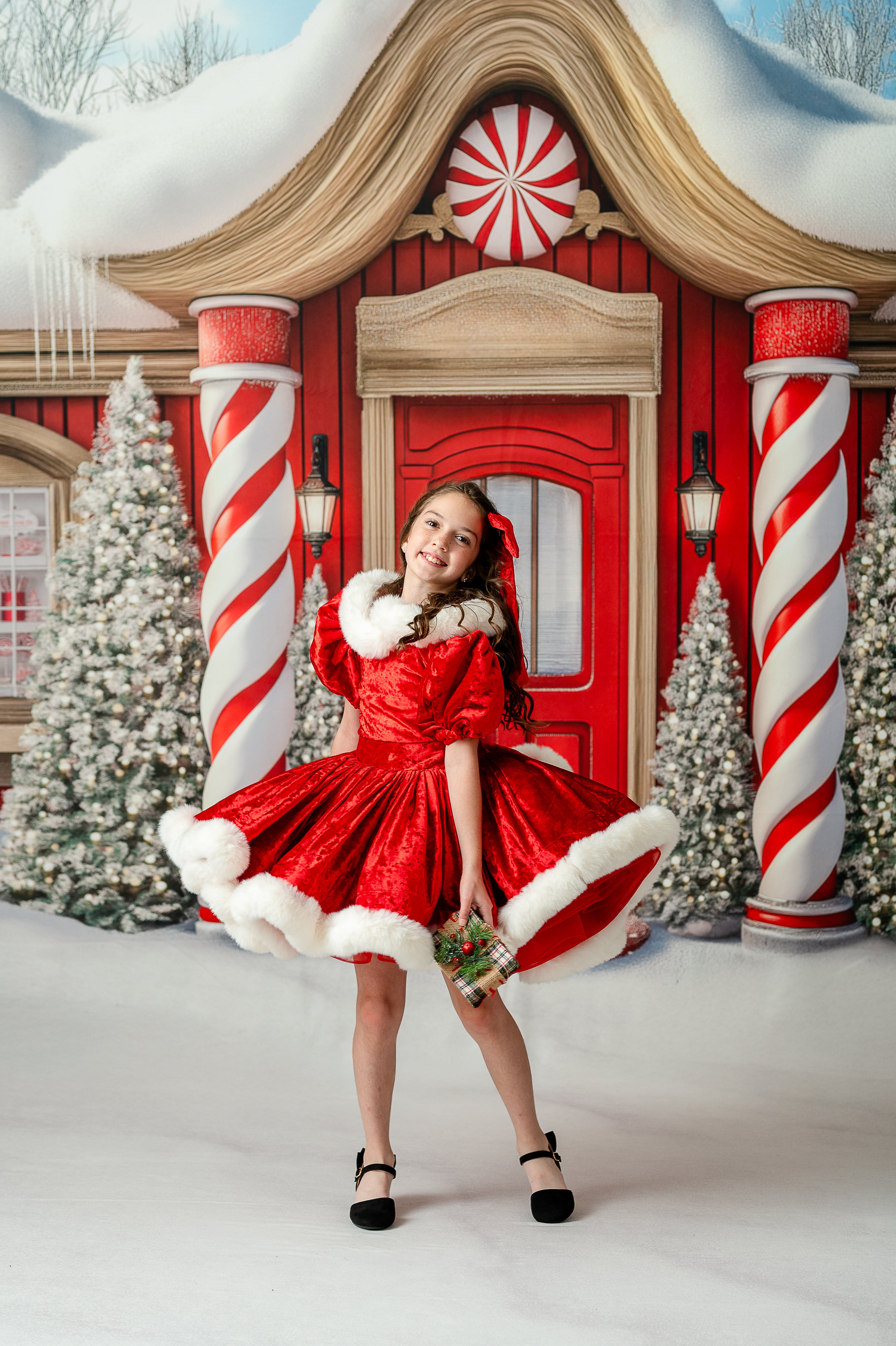 Child twirling in Mrs. Claus holiday gown with layered skirt and cape