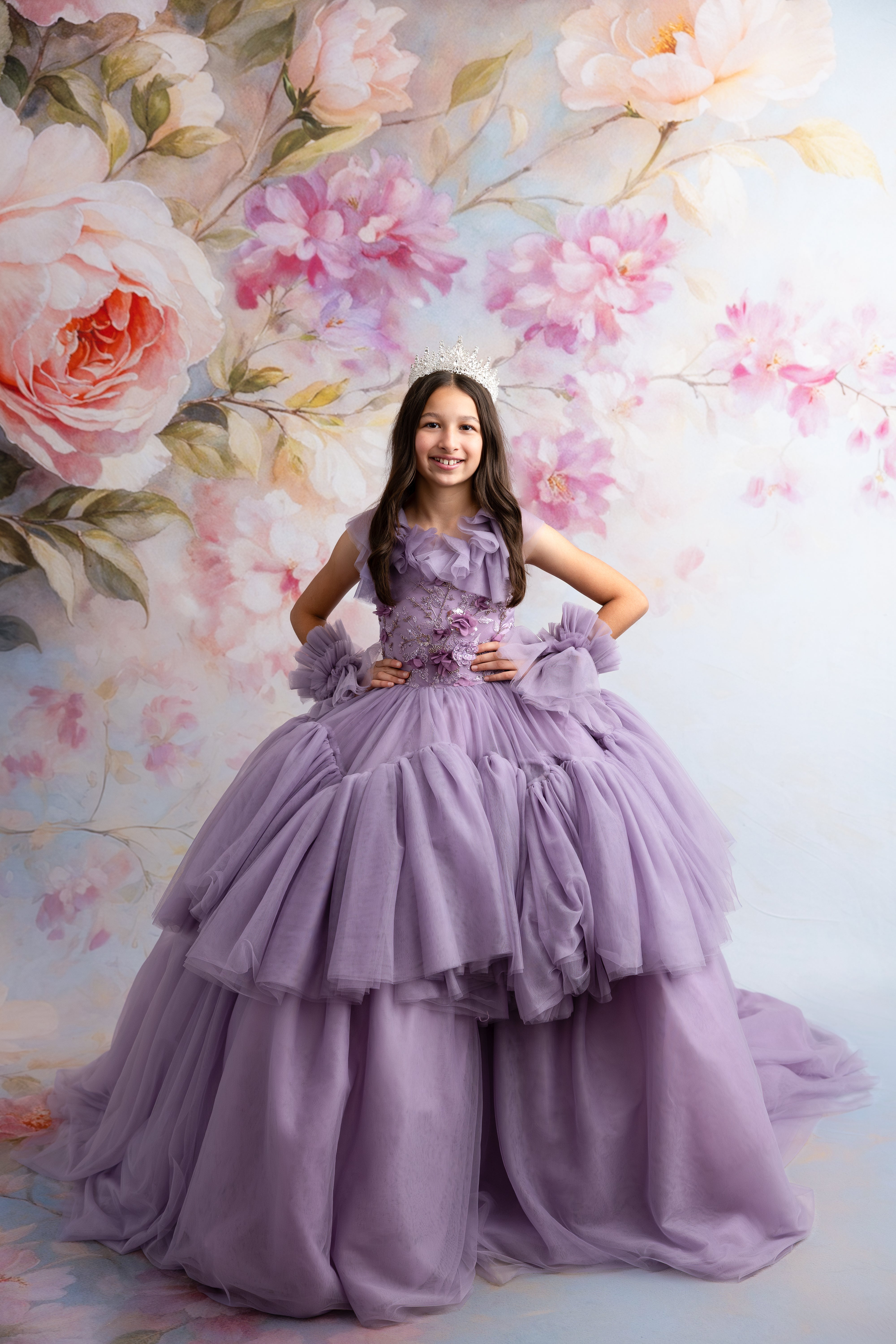 Girl wearing Violet Grace gown with floor-length tiered tulle skirt in soft violet
