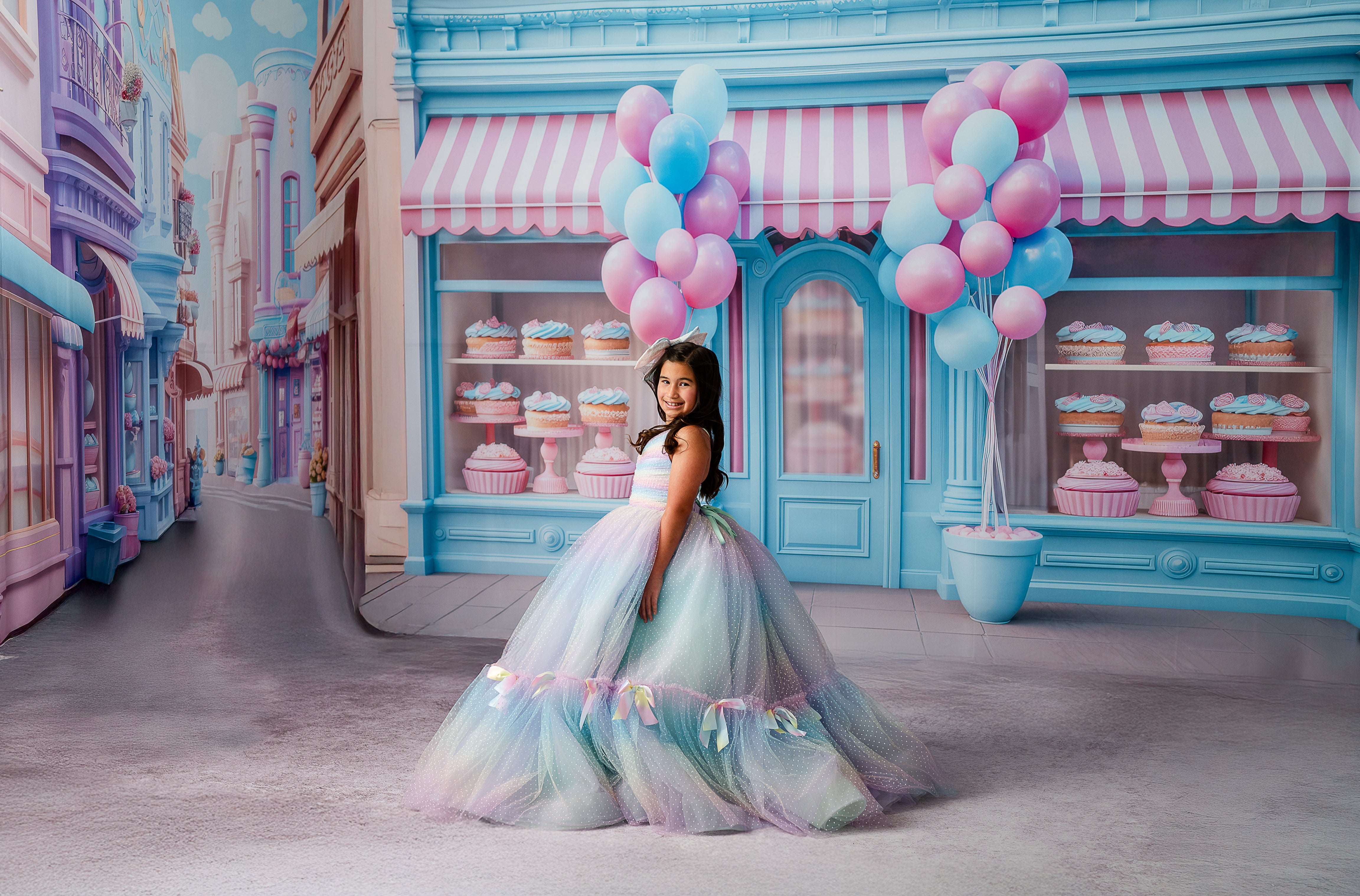 Full view of the Colorful Bliss Gown styled on a young model, featuring layered tulle and rainbow satin bows for a magical twirl-ready look.