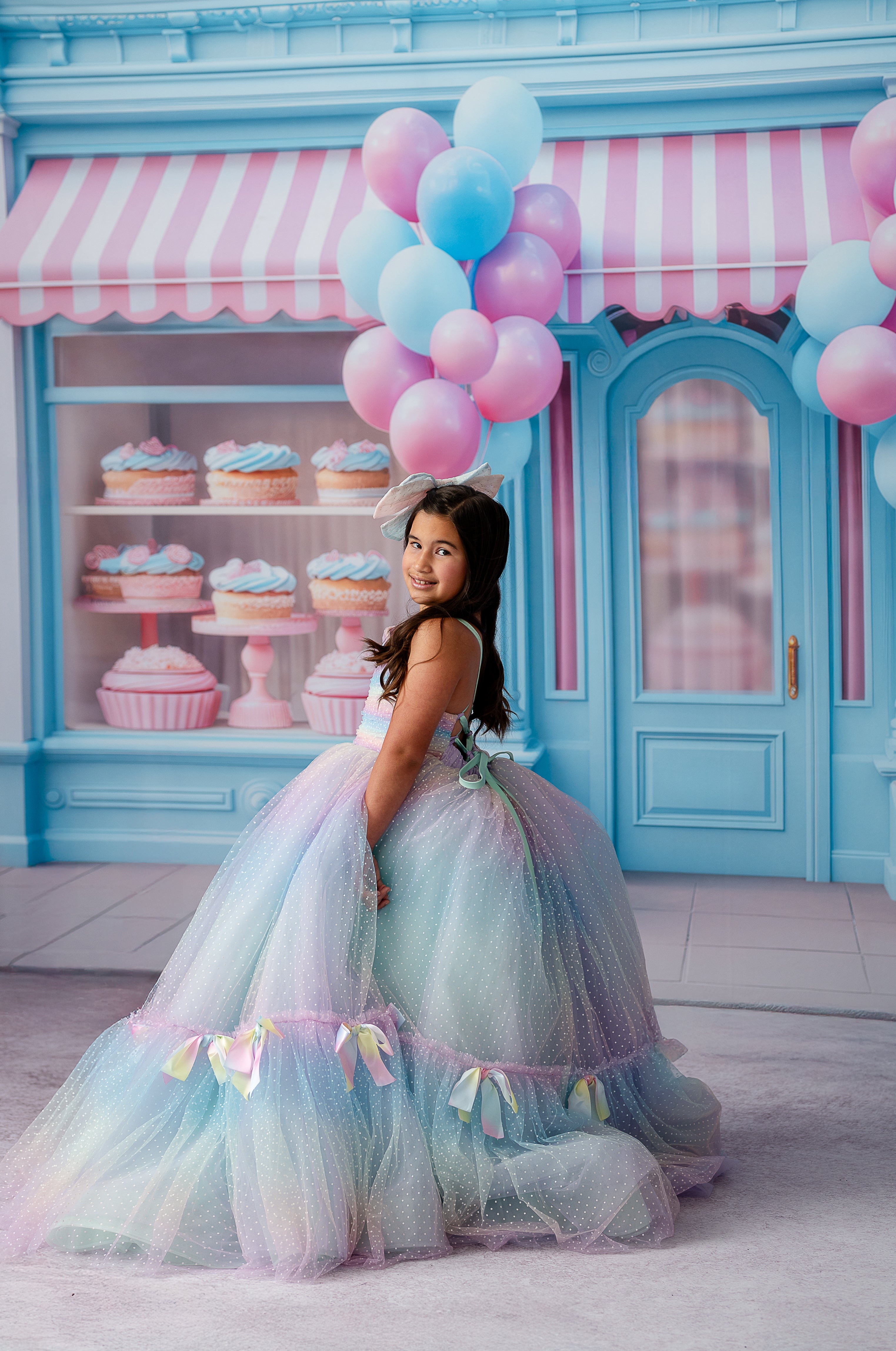 Side profile of a girl wearing the gown, revealing the rainbow detailing and hemline bows, captured by Kayla Rinehart Photography.