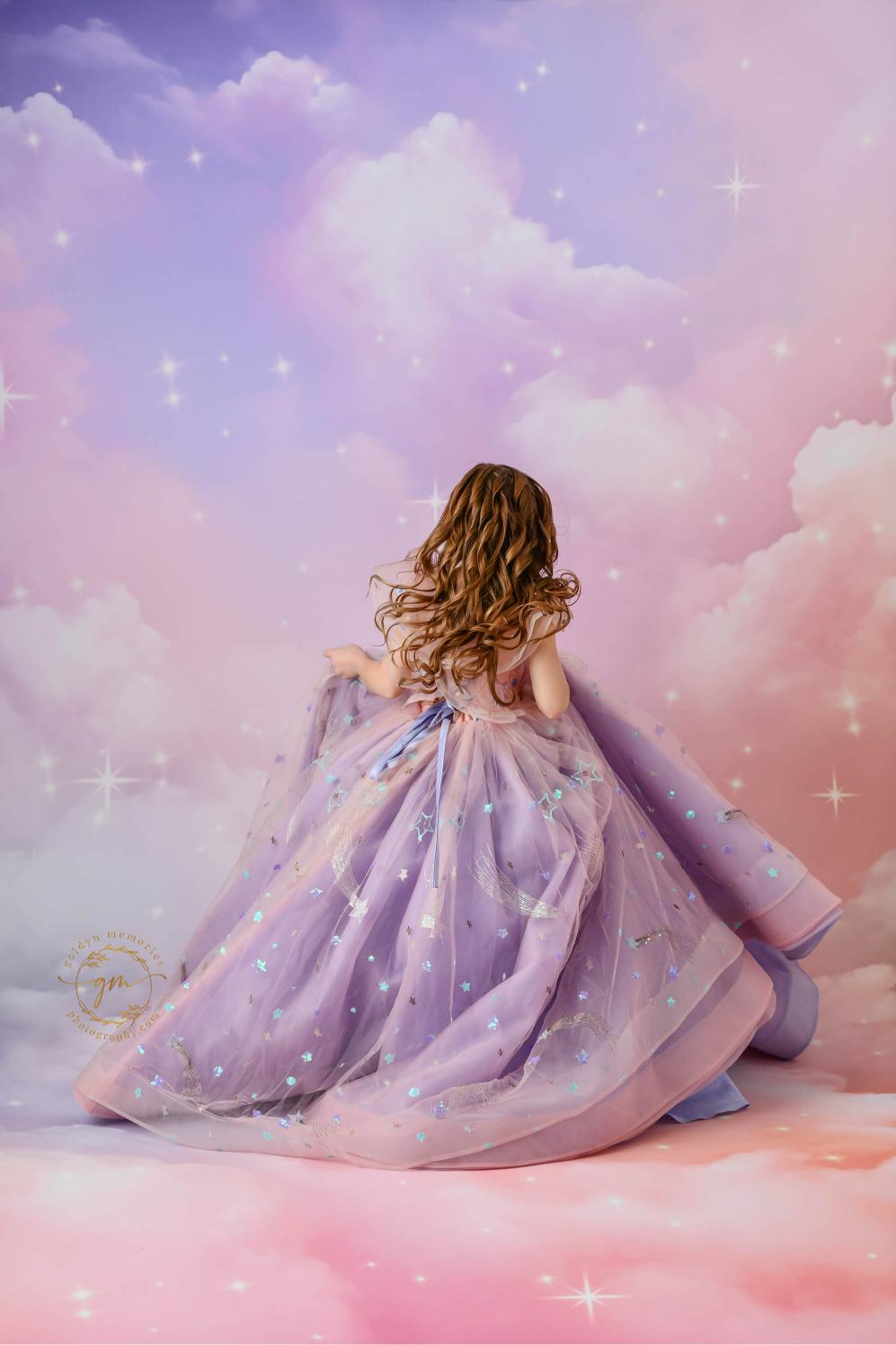 "A magical portrait of a girl in a flowing pink and lavender dress, perfect for a fantasy-themed photoshoot."