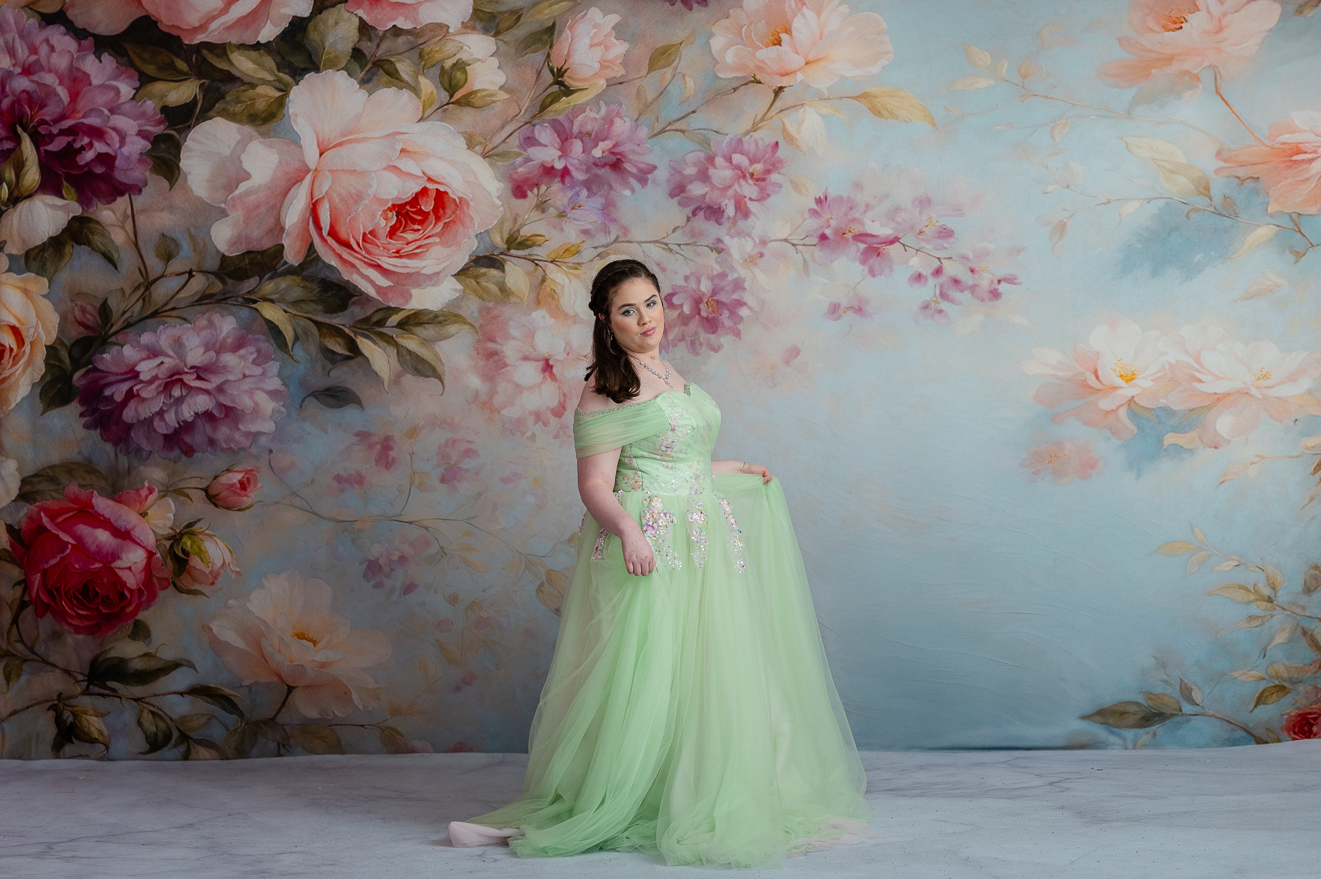 Young girl in sequin gown smiling brightly during outdoor portrait session