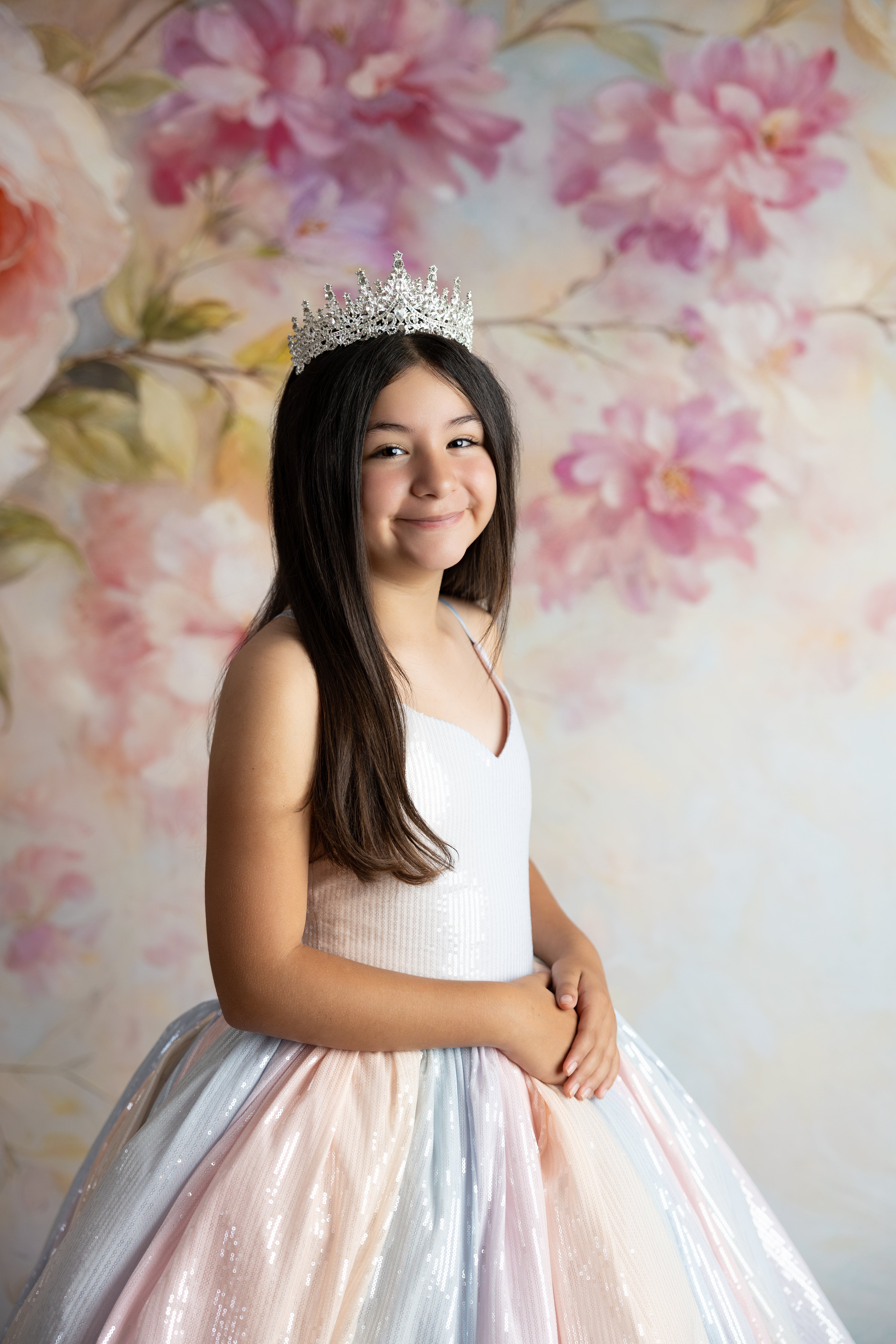 Girl posing in the Aurora Gleam Gown with detachable tulle sleeves floating gently