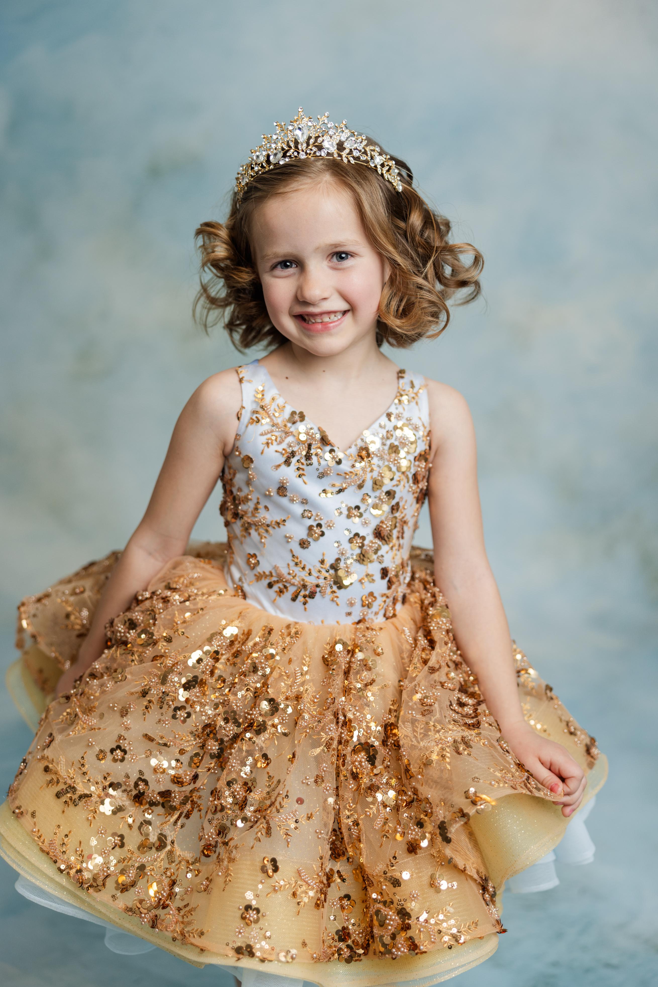 "Elegant Cinderella’s Glow gown with golden sequin bodice and soft flowing tulle layers"
