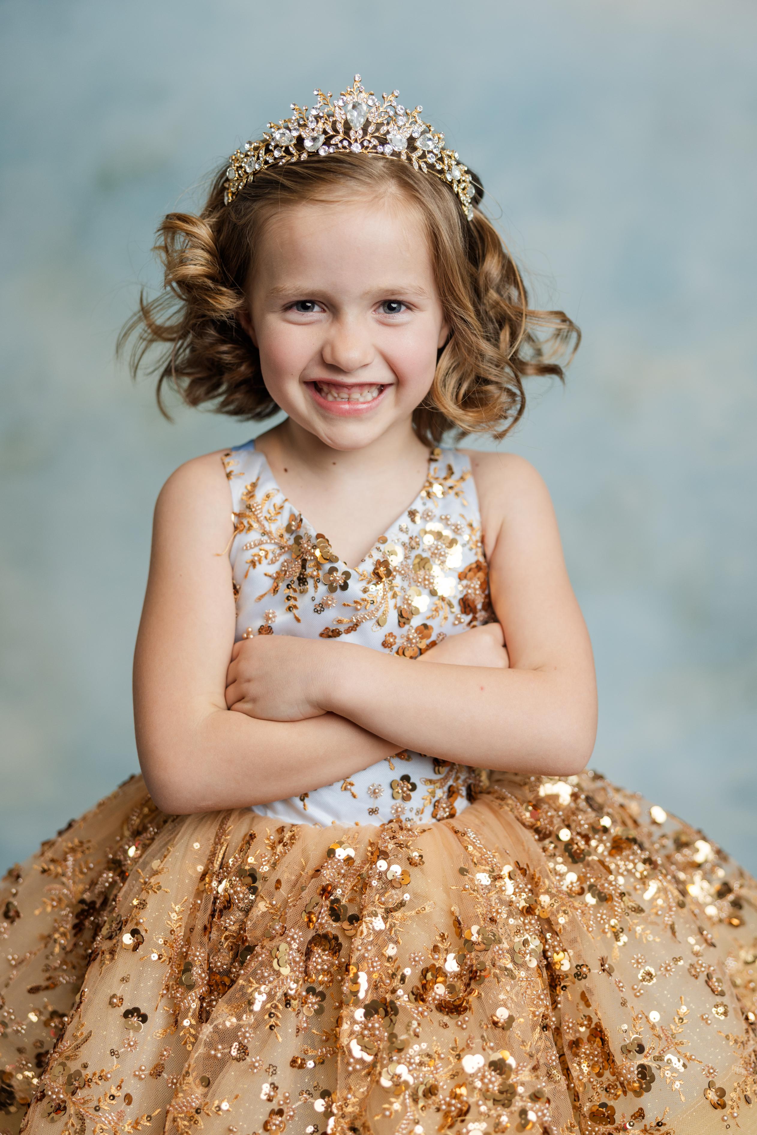 "Cinderella’s Glow gown featuring shimmering golden sequins and layered airy tulle"