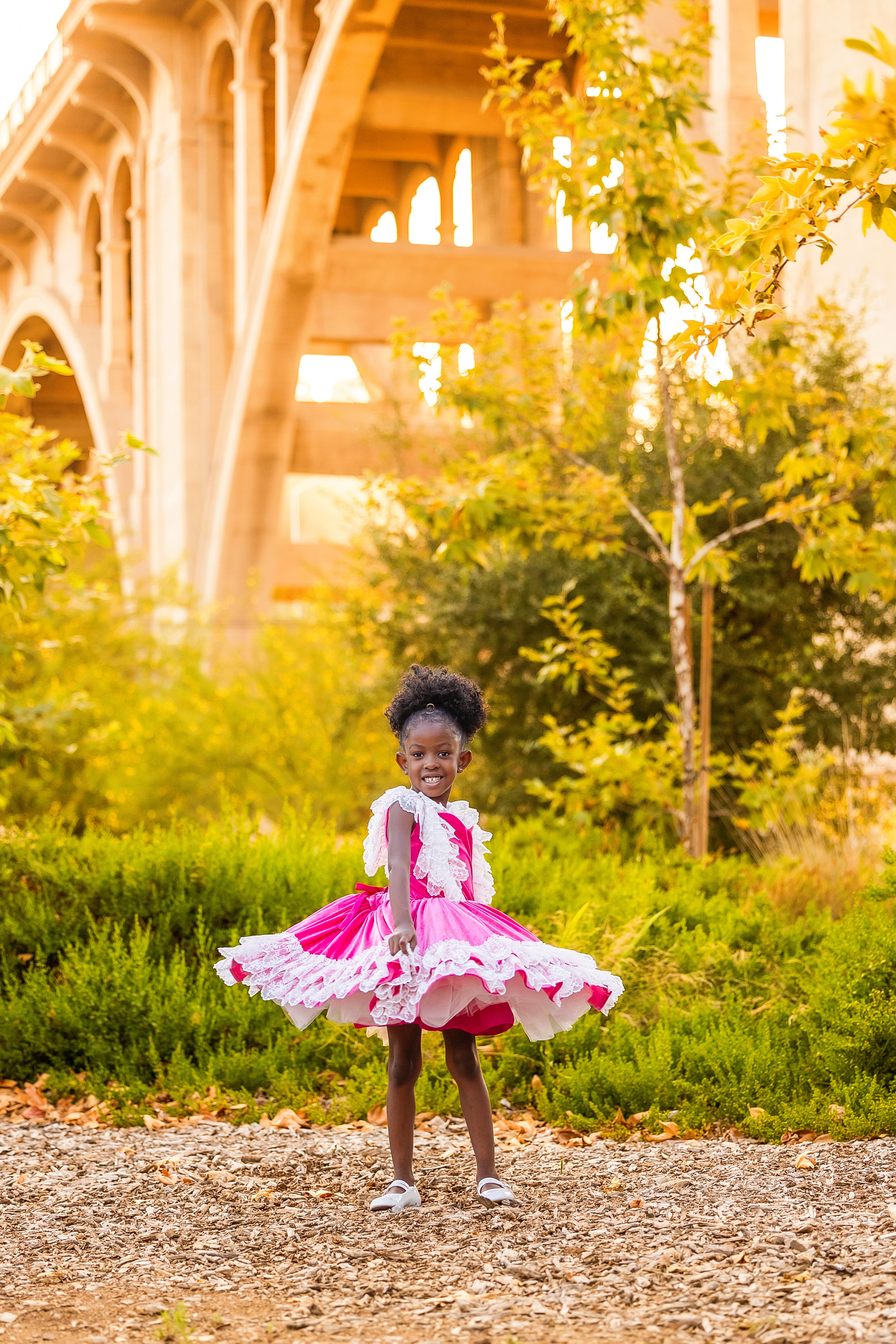 Close-up of the "Sweetheart Serenade" dress highlighting its intricate details, worn by a child in a charming vintage-inspired location.