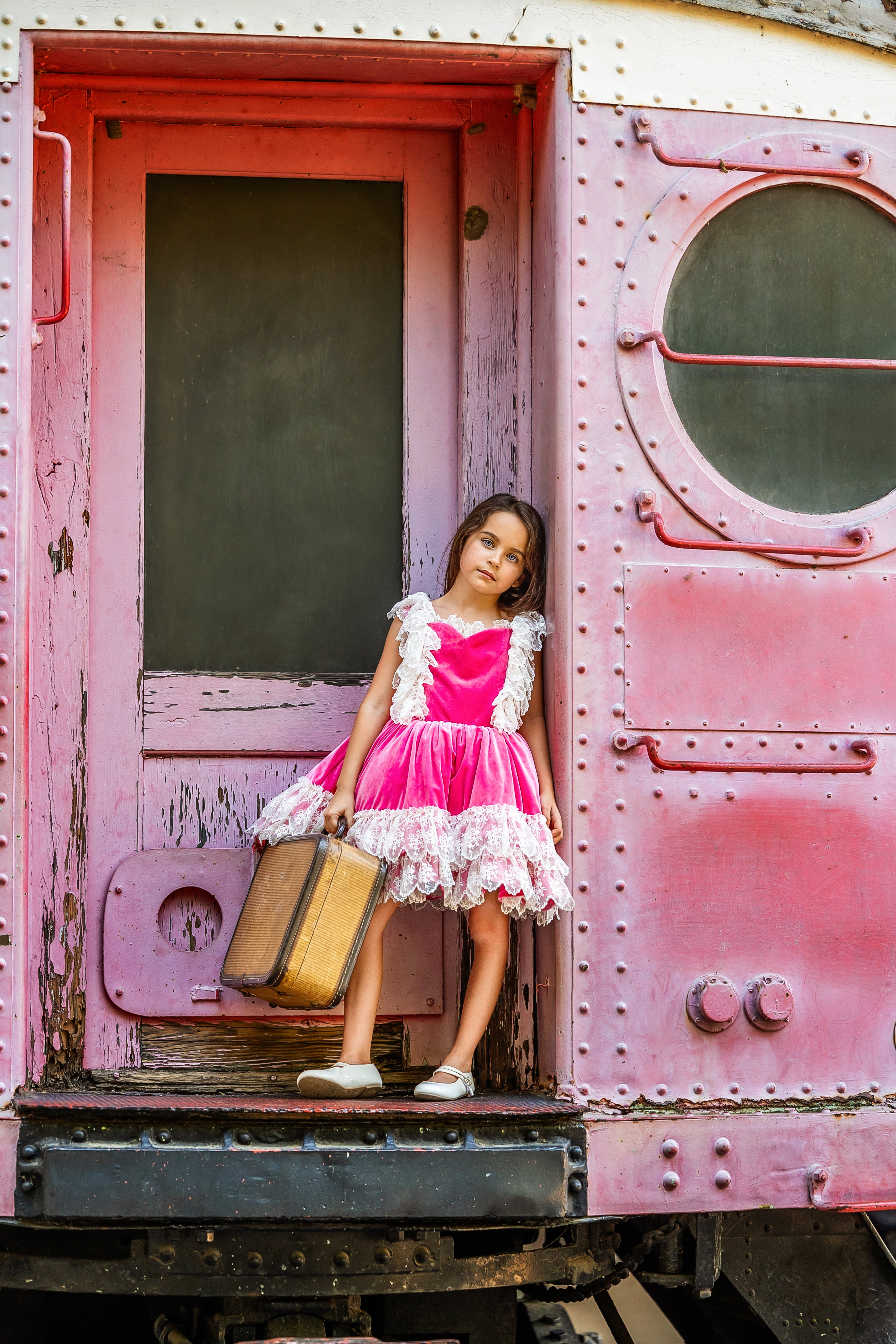 Young model wearing the "Sweetheart Serenade" vintage-length gown in a whimsical indoor setting, capturing the gown’s classic charm and grace.