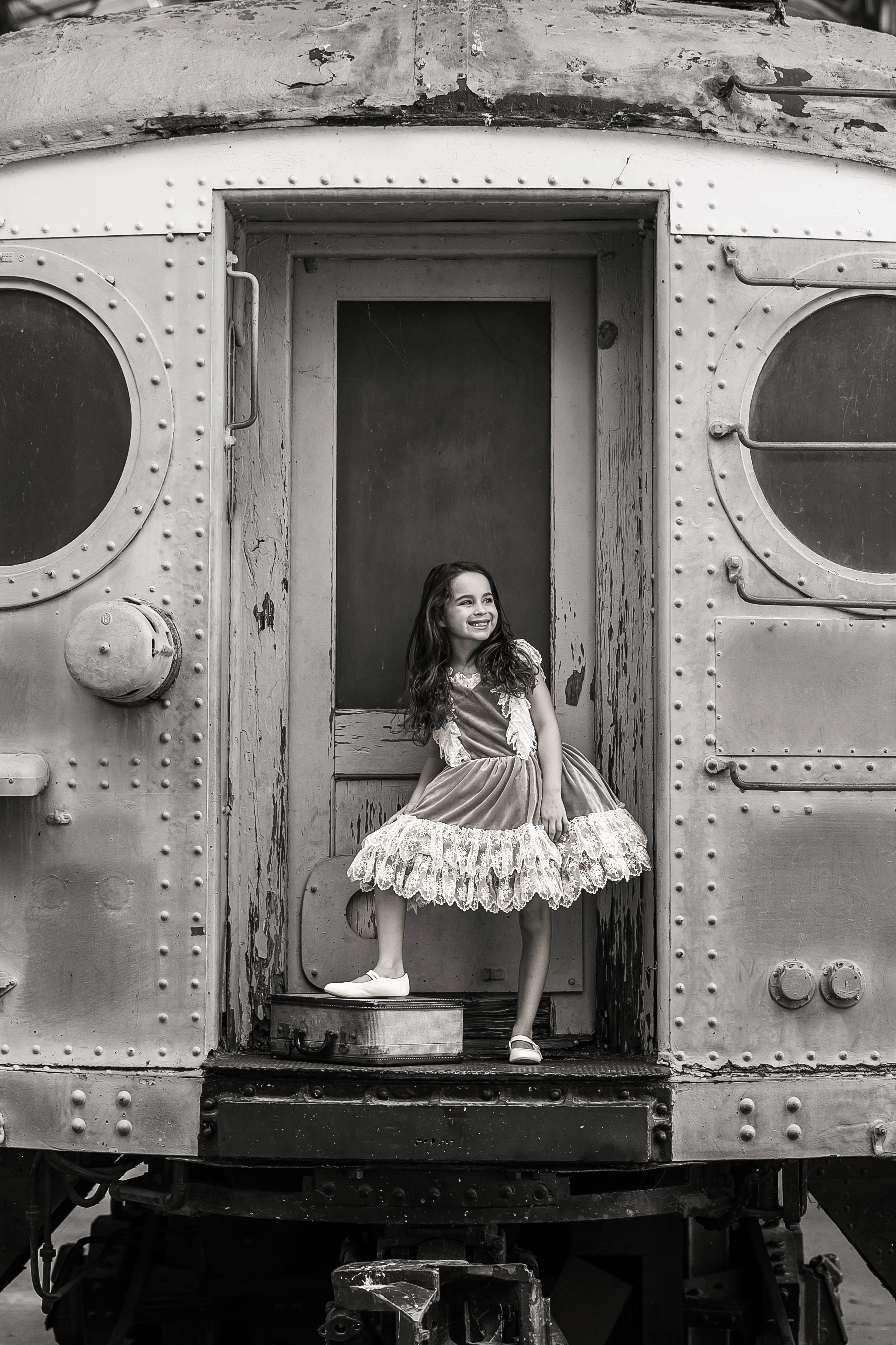 Vintage-length 'Sweetheart Serenade' dress photographed in a sunlit garden setting with a young girl twirling.