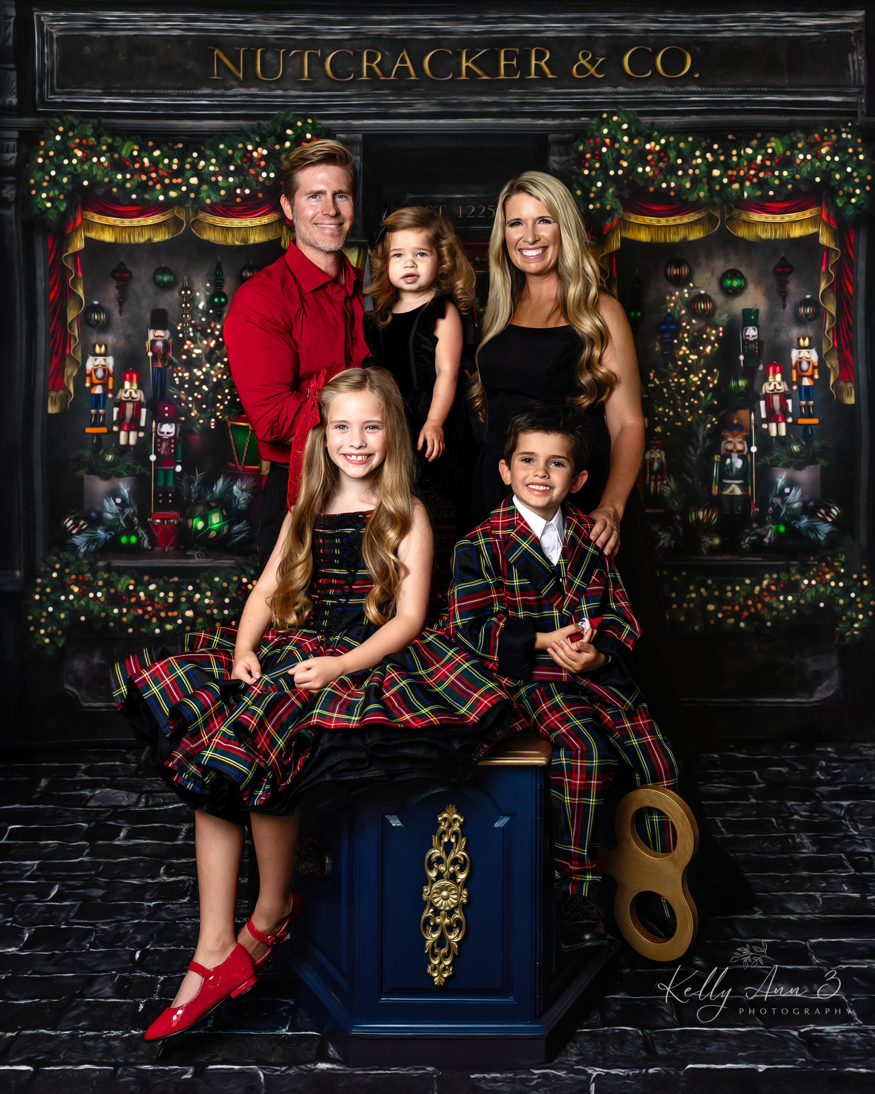 Family posing in front of a Nutcracker & Co. display with a decorated Nutcracker in the background.