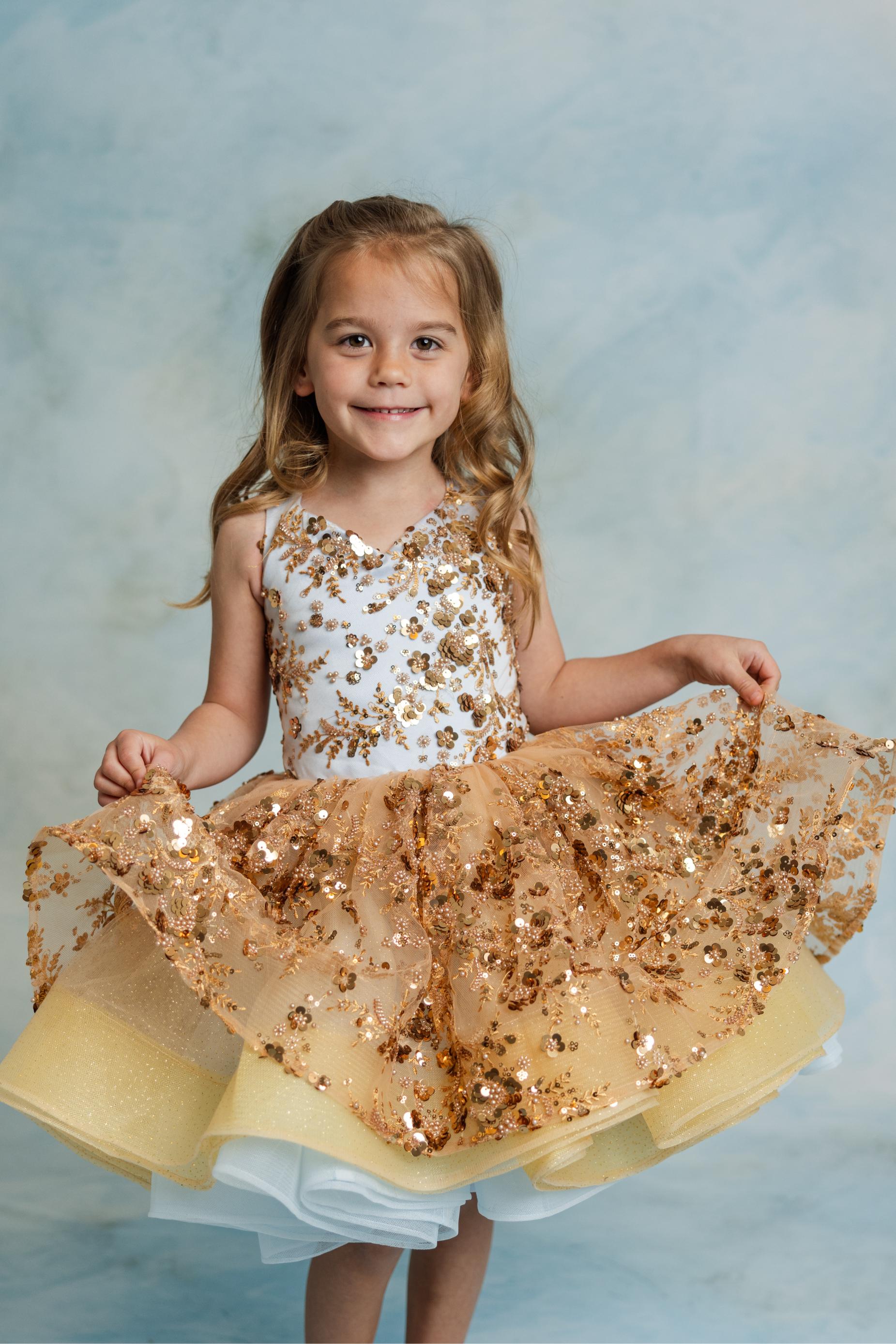 Cinderella’s Glow gown with golden sequins and airy tulle elegance.