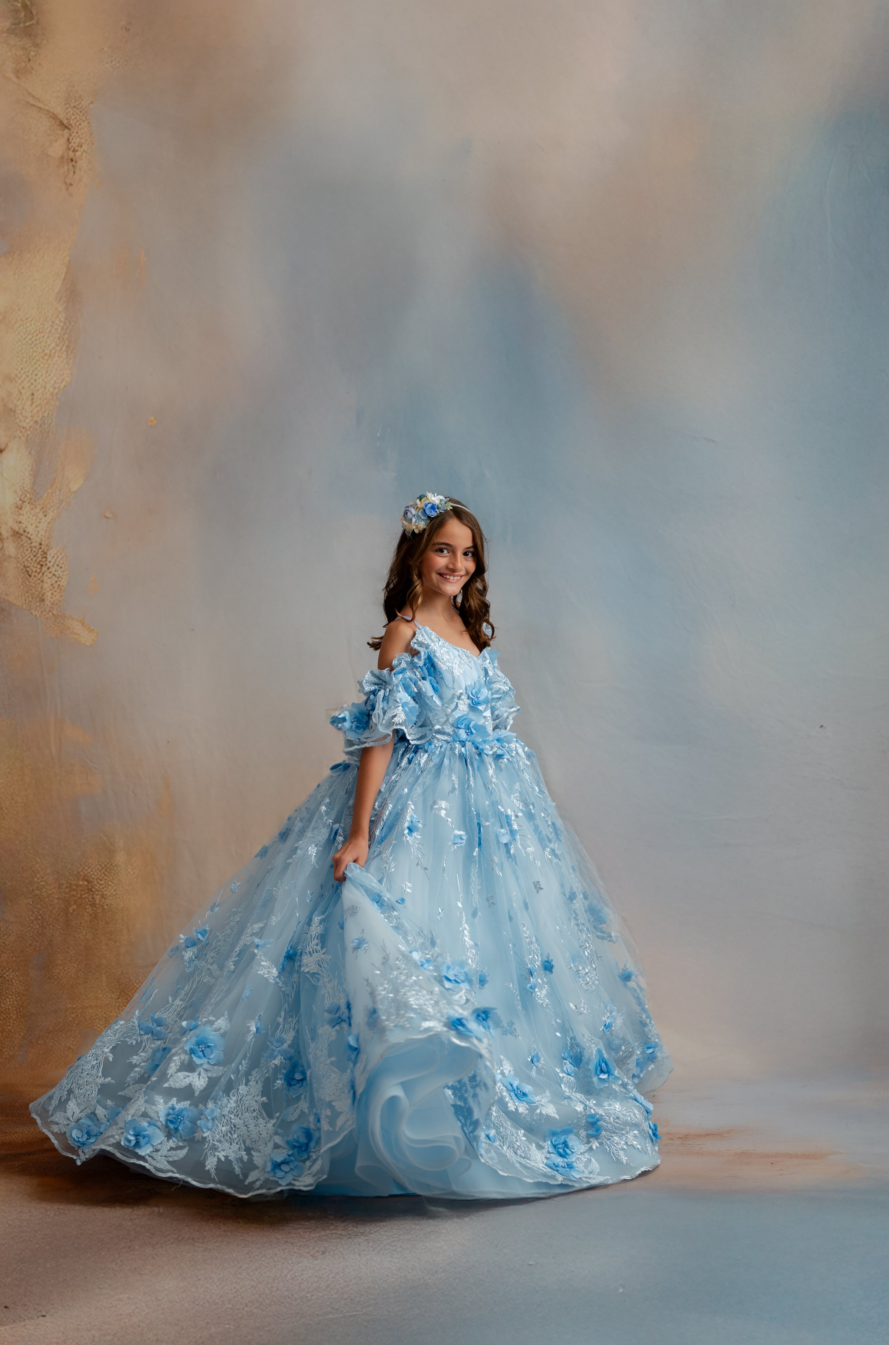 Woman in a blue floral gown with a soft, blurred background