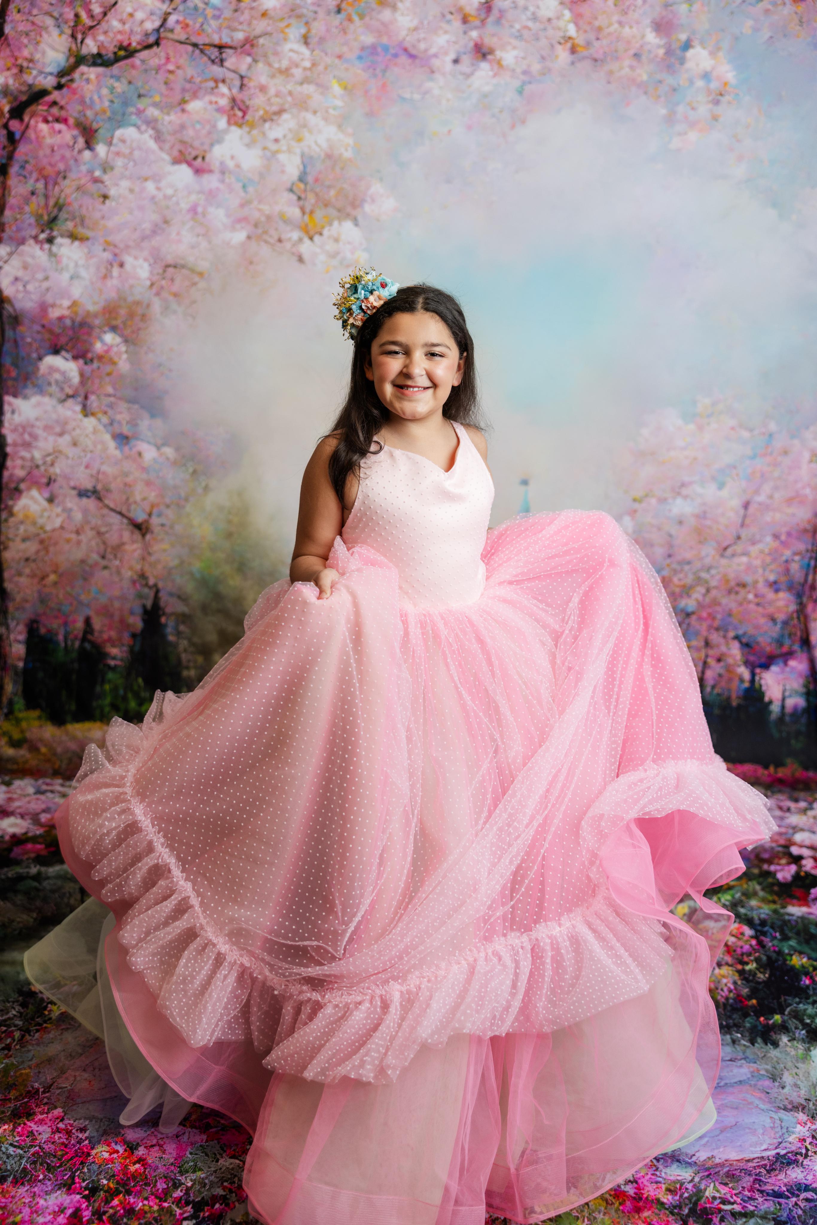 "Full view of the Swish Dot Couture Pastel gown featuring layers of pink Swiss dot fabric and soft tulle in shades of pink, sage, and soft blue."