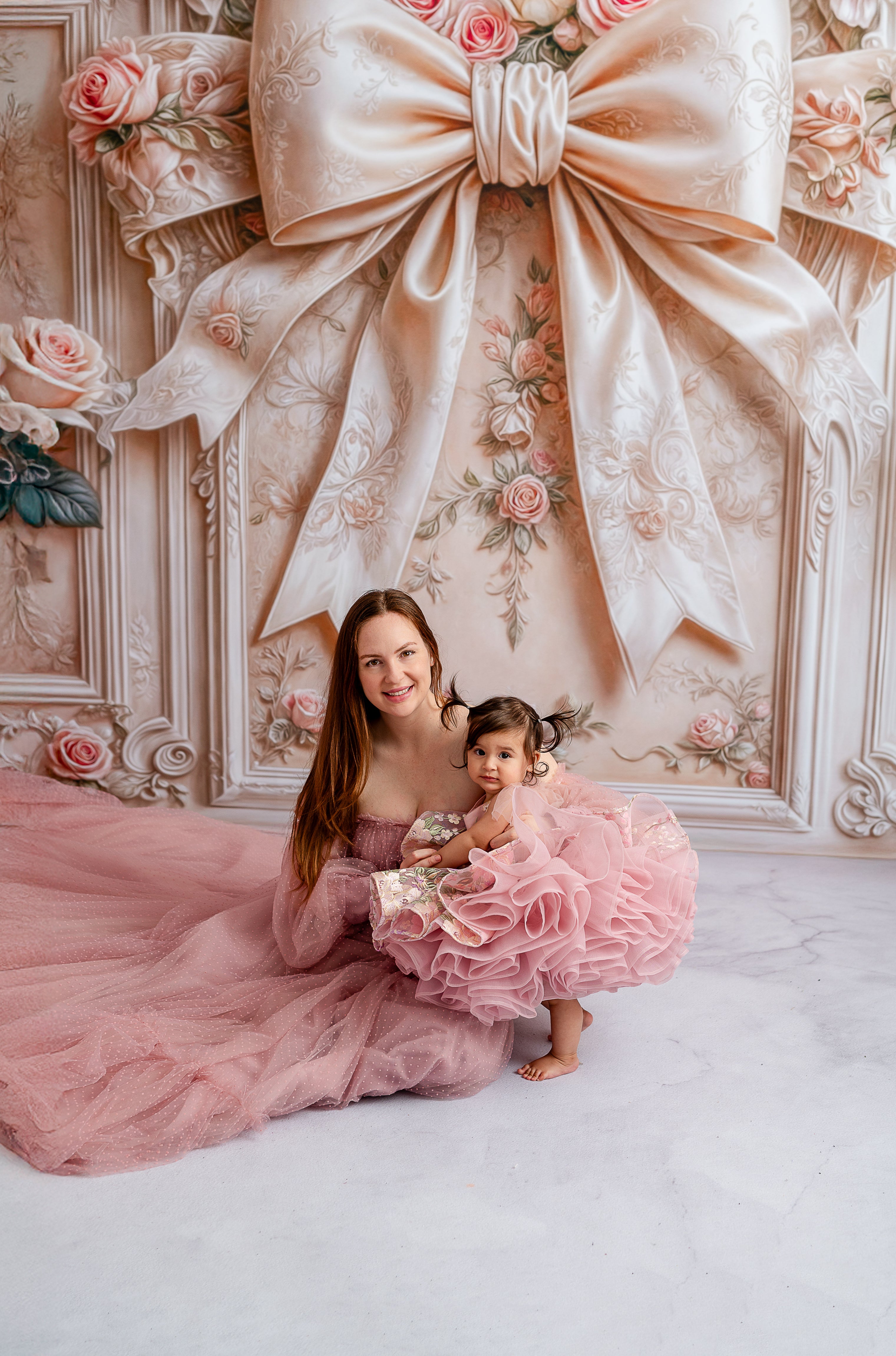 Mother and child in coordinated couture dresses for portraits