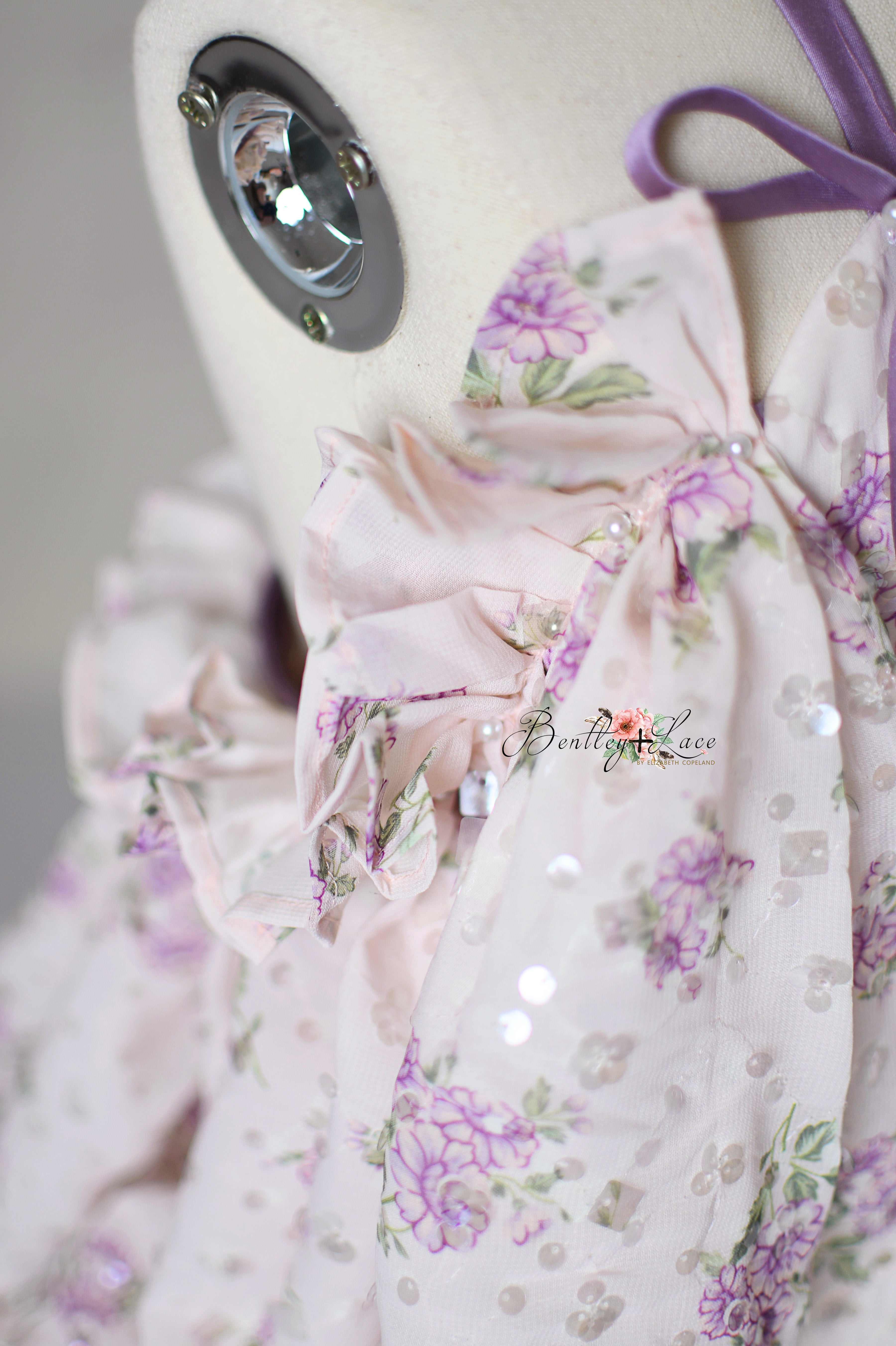 Whispering Serenade gown displayed with matching floral headband for photoshoots.