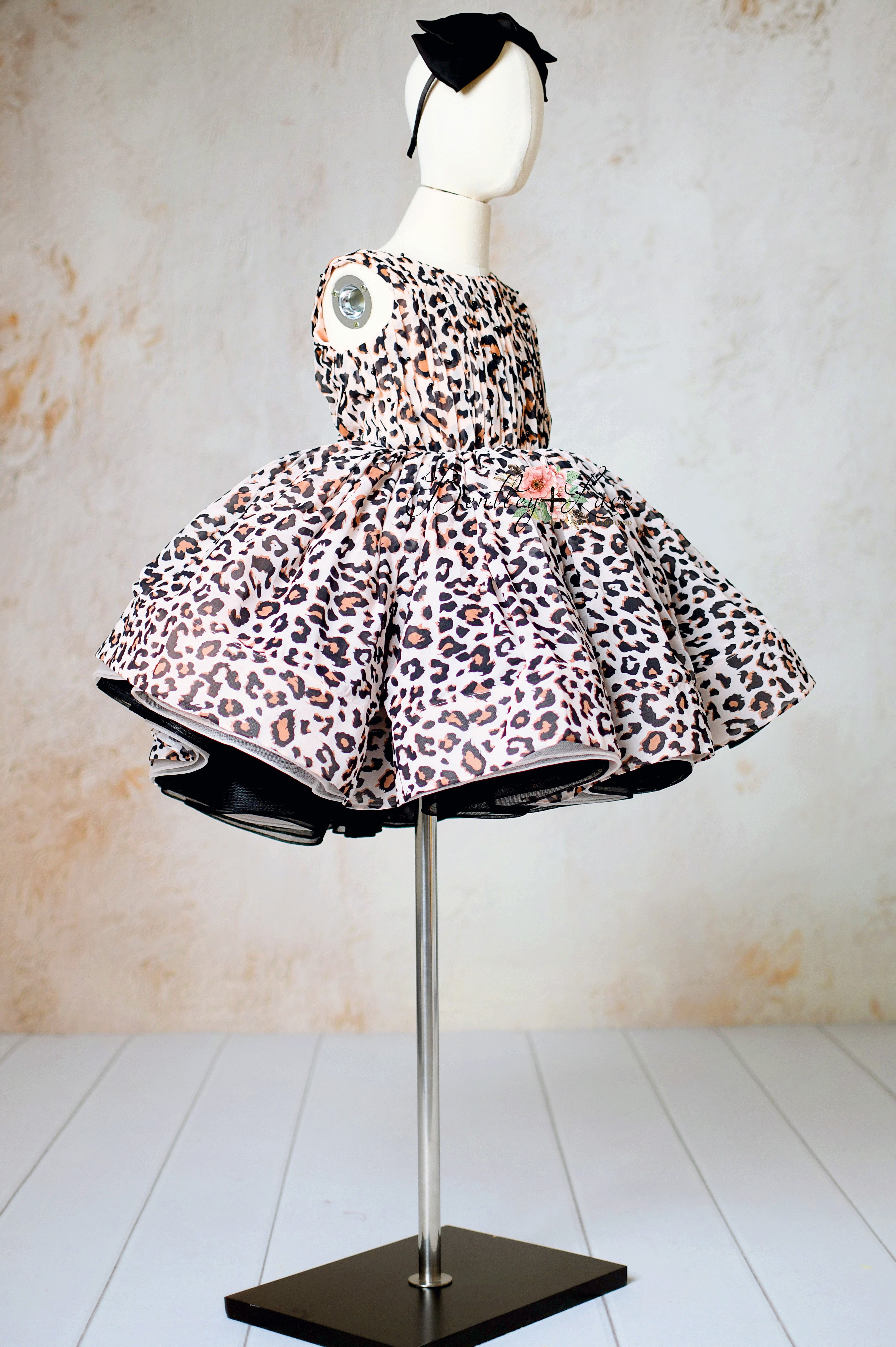 "Twirl-ready petal-length leopard print dress for kids aged 6-8 years."