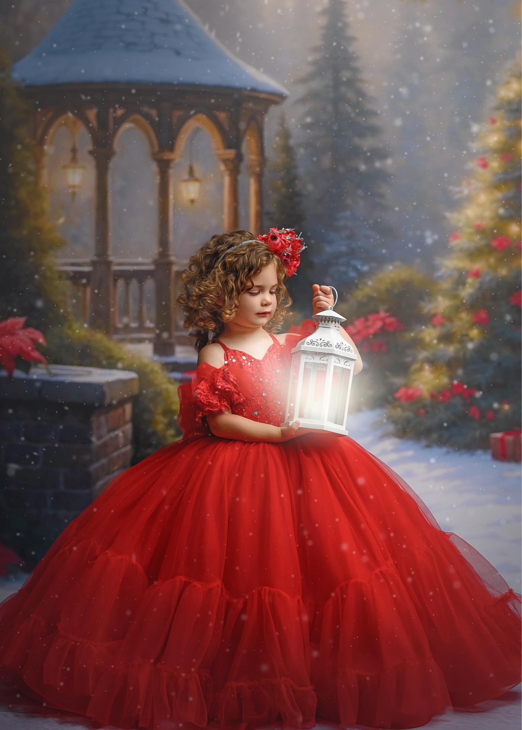 Little girl wearing a beautiful red holiday gown.