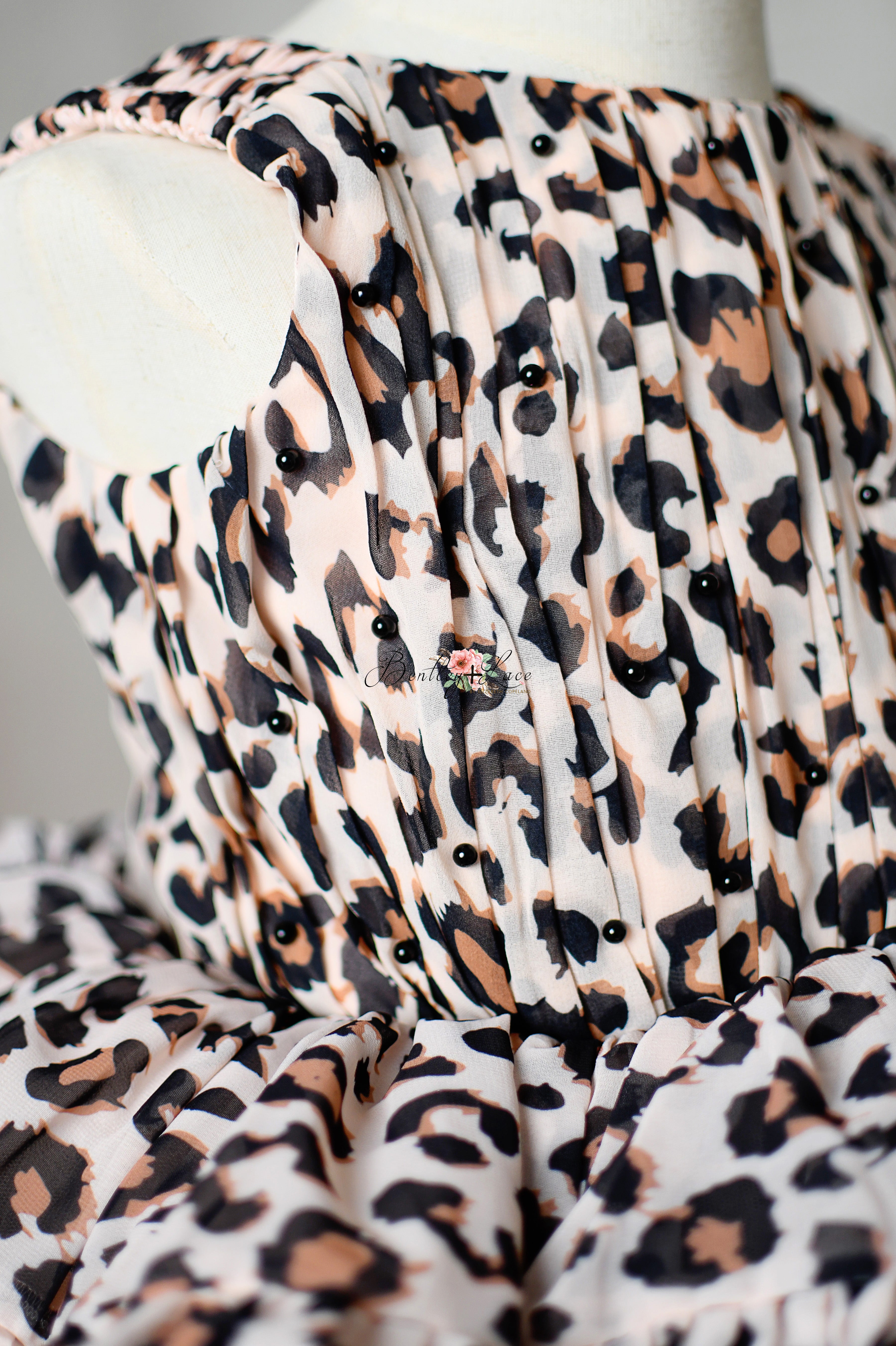 "Leopard print dress for toddlers with puff sleeves and twirl-worthy petal-length skirt."