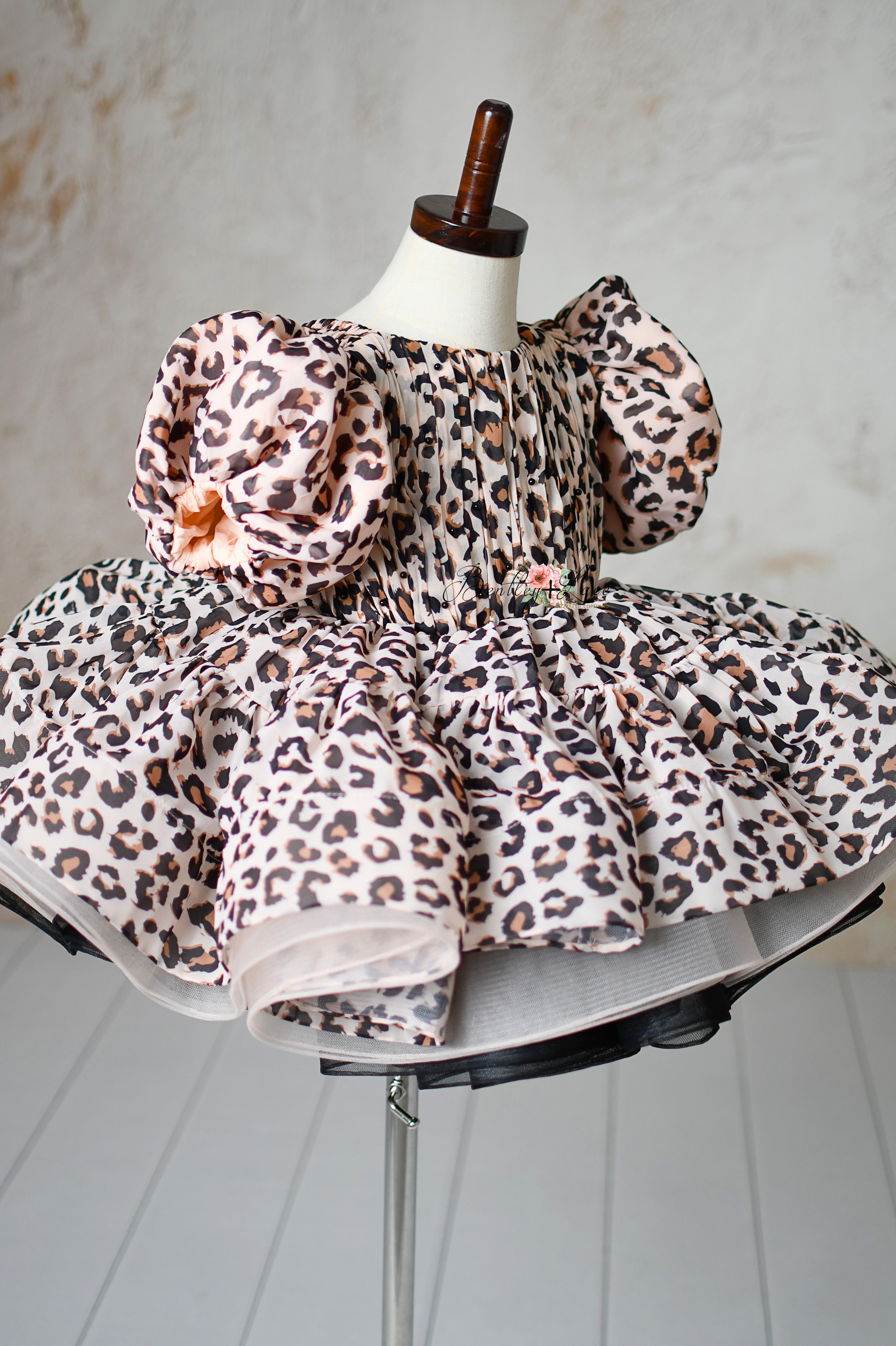 "Leopard print toddler dress with puff sleeves and adjustable fit for stylish photography sessions."