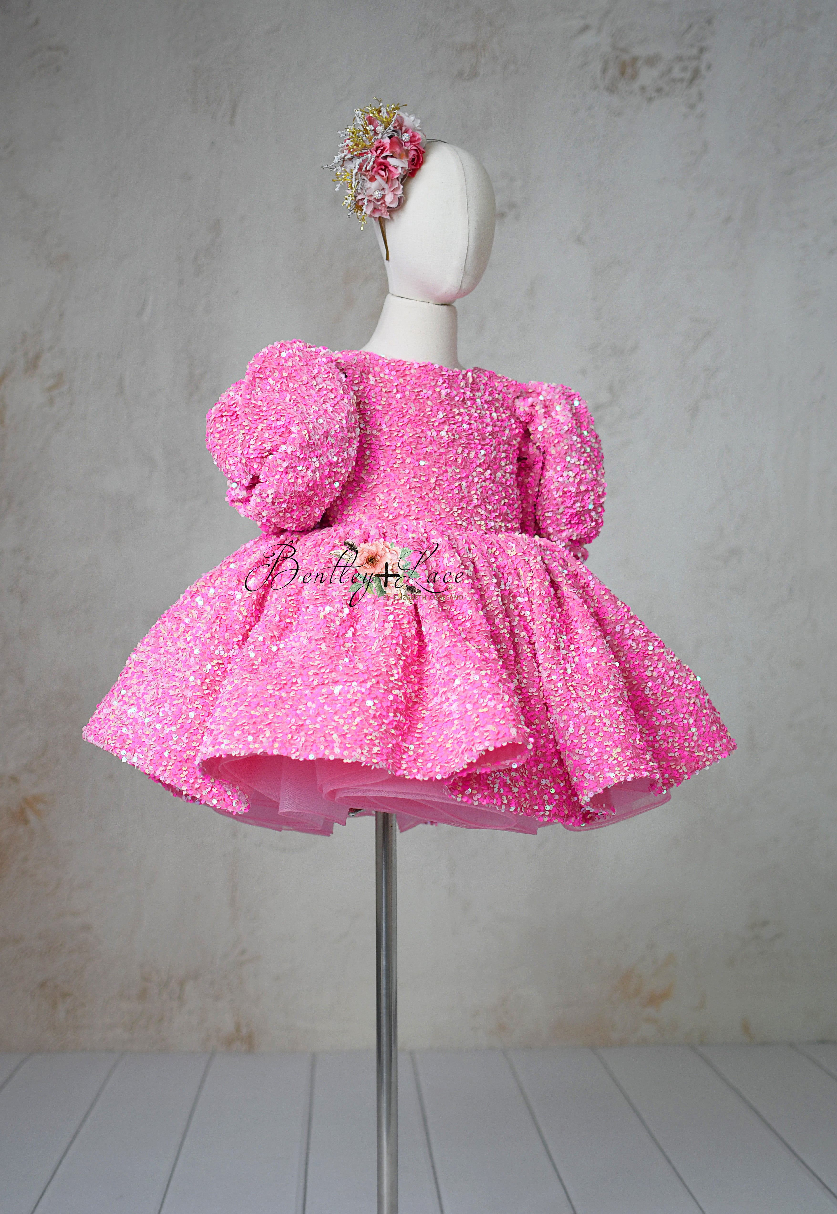 "Stylish Retro Pink Candy Dress with sparkly sequins and optional puff sleeves, perfect for ages 6-7."