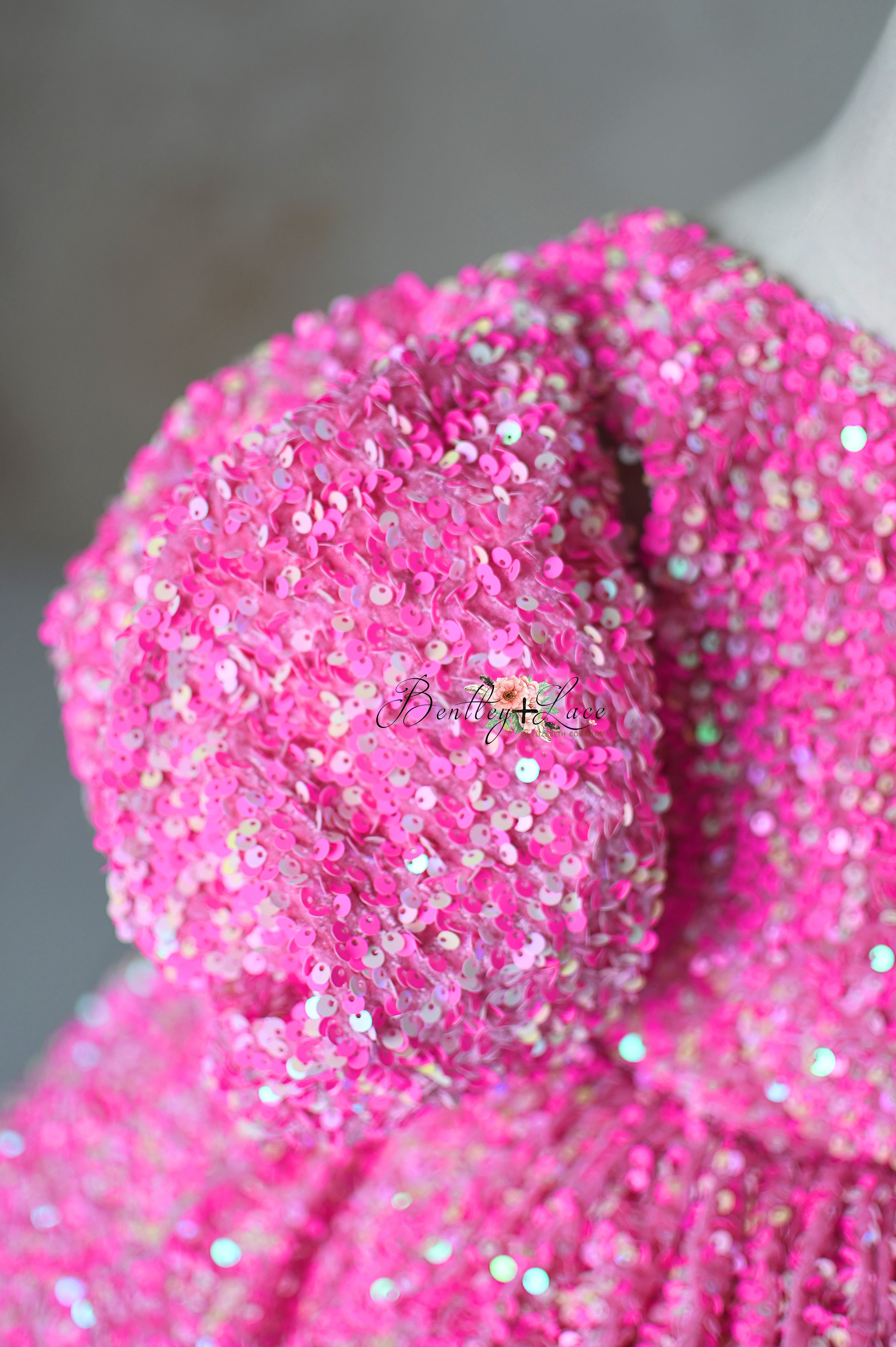 "Close-up of Retro Pink Candy Dress, showcasing pink sequins and puff sleeves designed for 6-7 year olds."