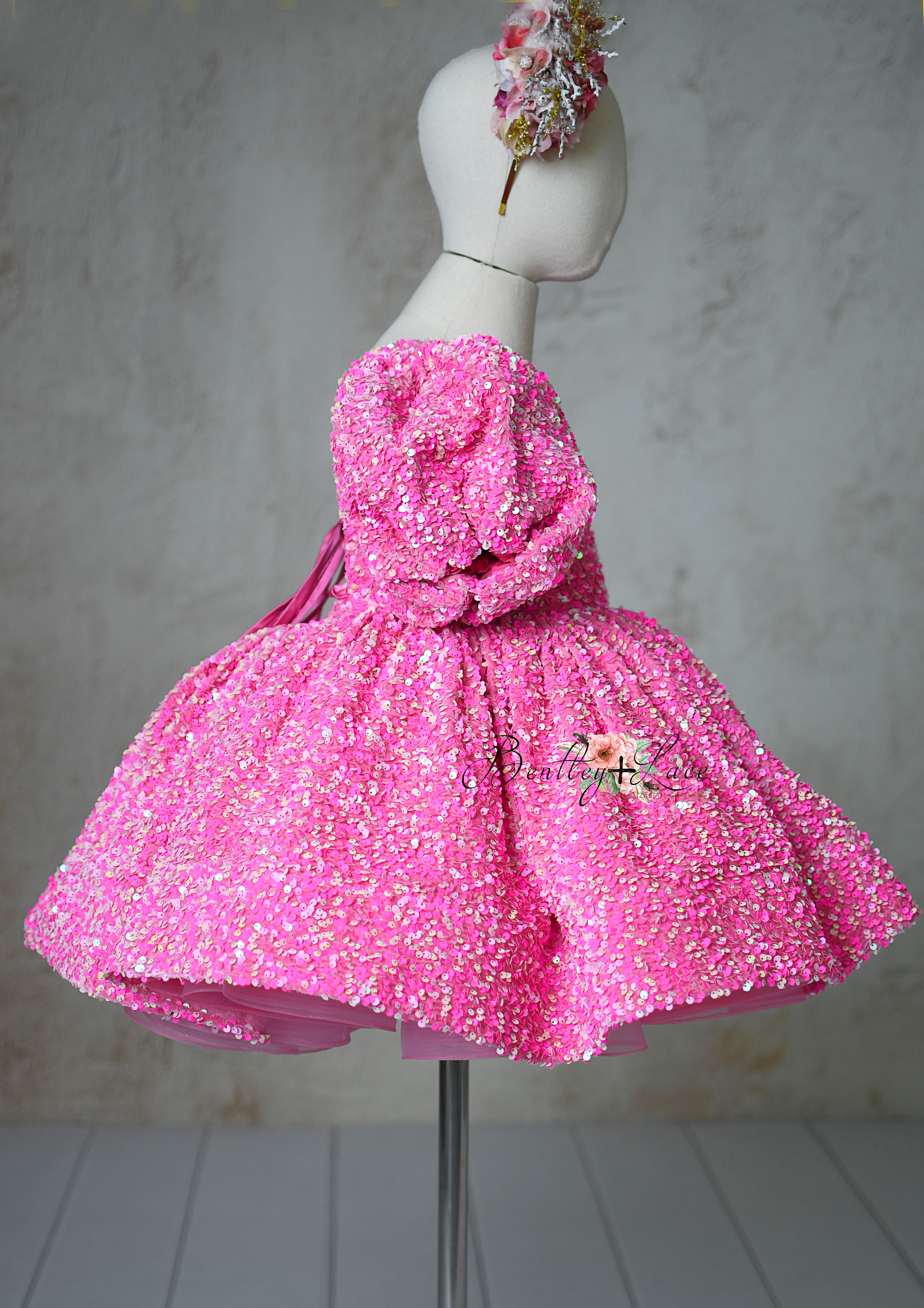 "Retro Pink Candy Petal Length Dress with removable puff sleeves for 6-7 year olds, featuring shimmering pink sequins."