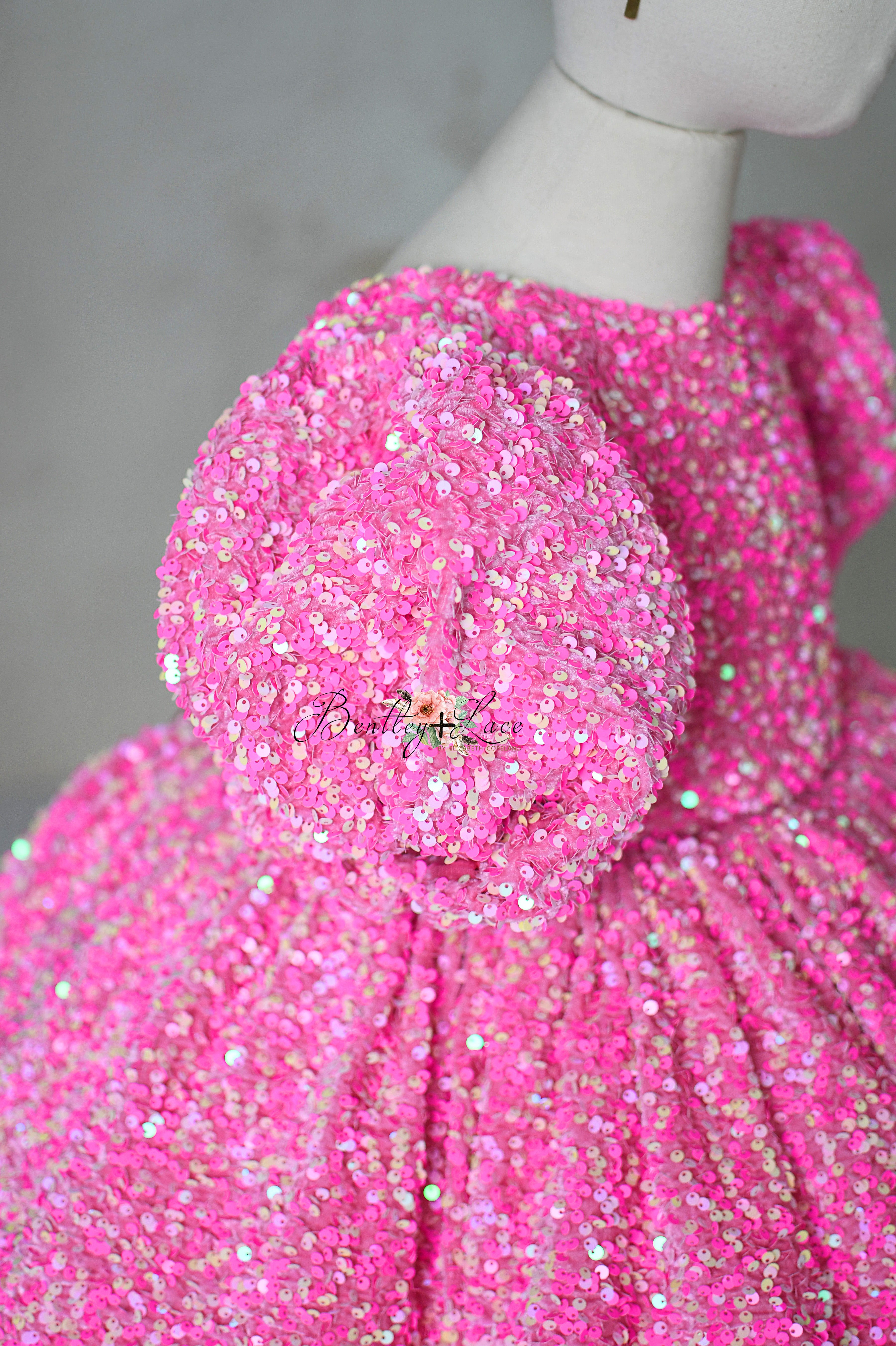 "Front view of a pink sequin dress with removable puff sleeves, Retro Pink Candy style for 6-7 year olds."