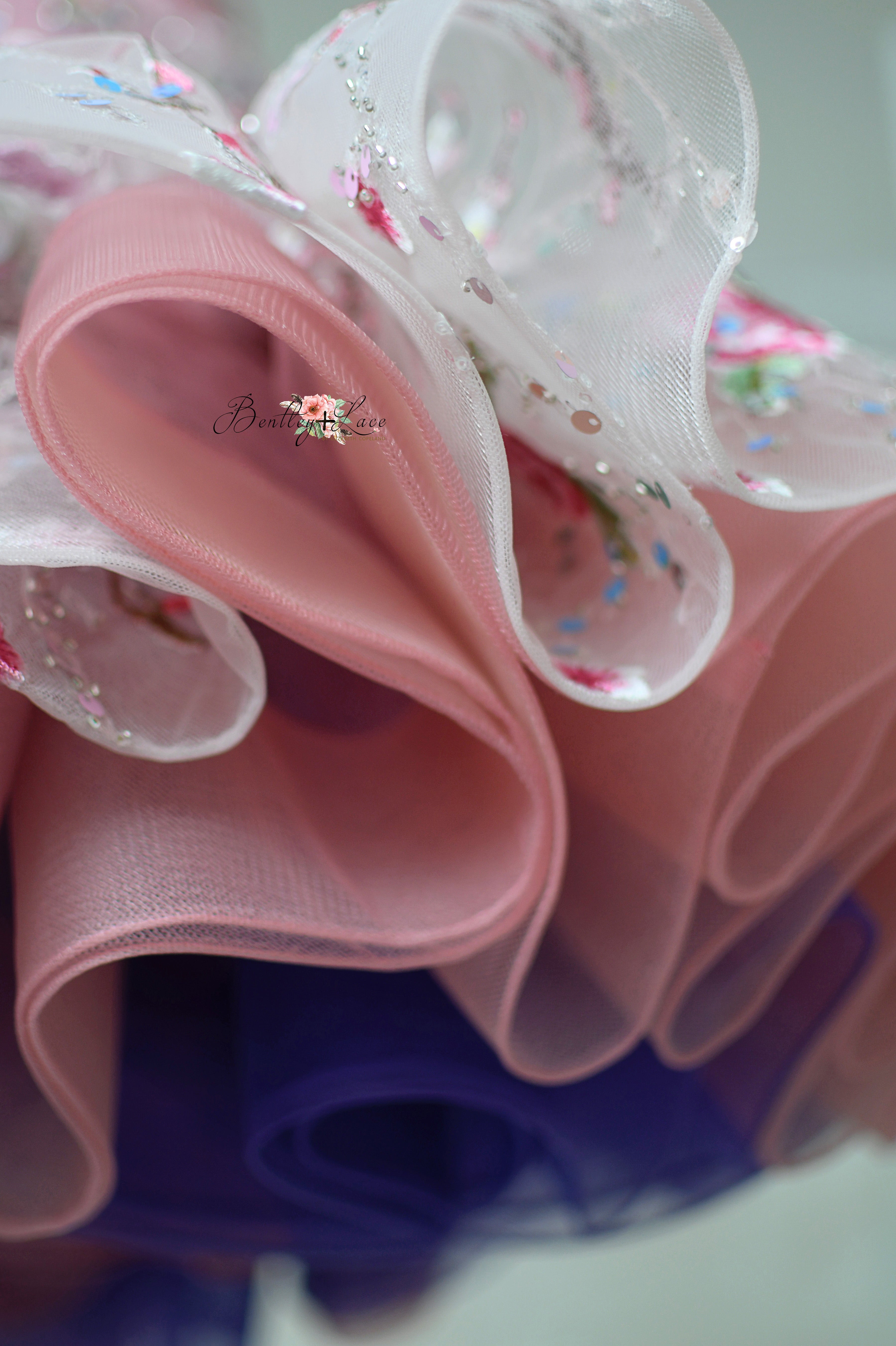 Cherry blossom floral sequin tulle fabric with subtle shades of purple in the skirt.