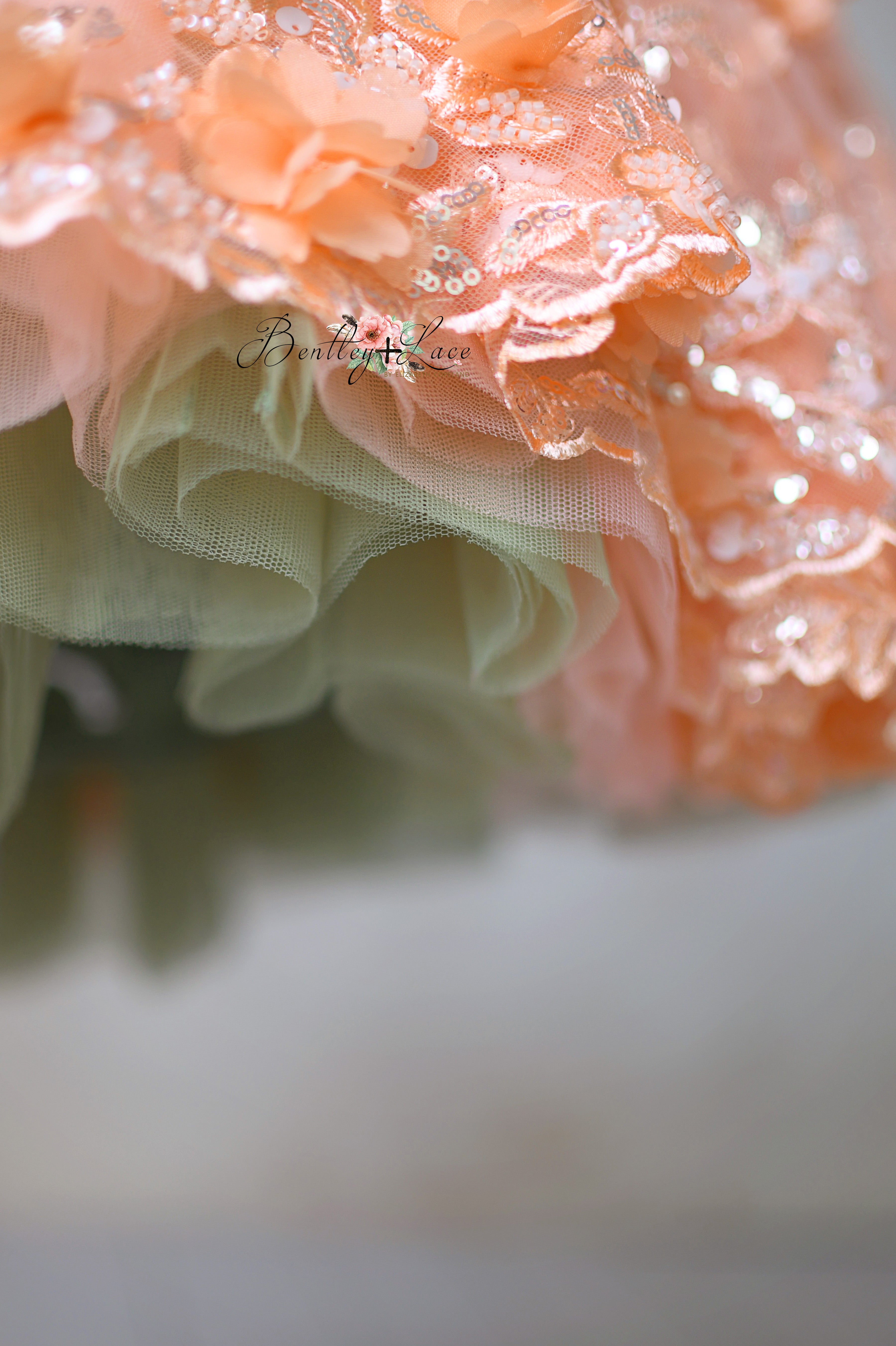"Close-up of the 'Peach Blossom' dress, showcasing the vintage-inspired petal-length design and floral fabric for 4-5 year olds."