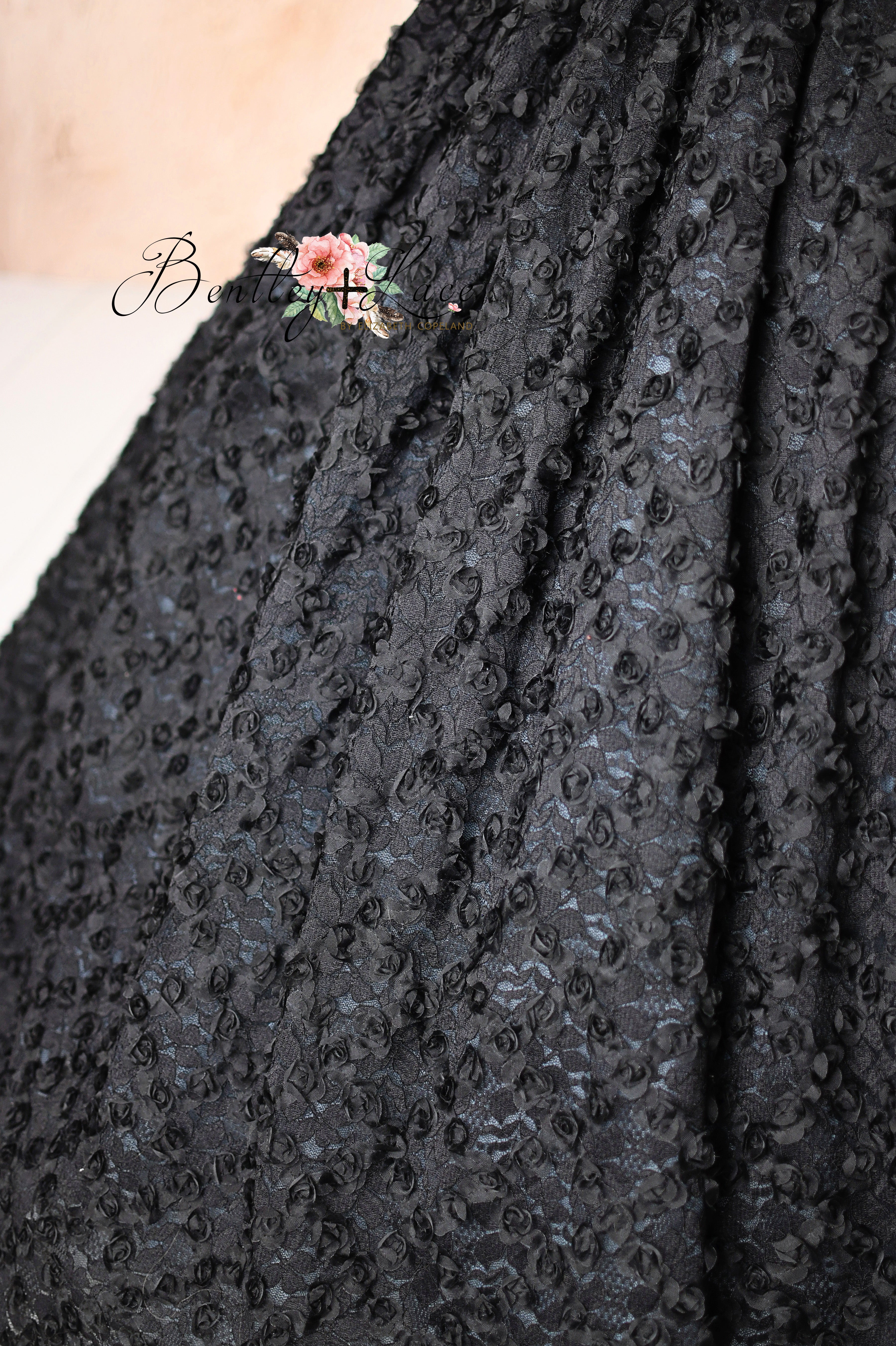 Unique couture dress with colorful butterflies and a flowing black textured skirt.