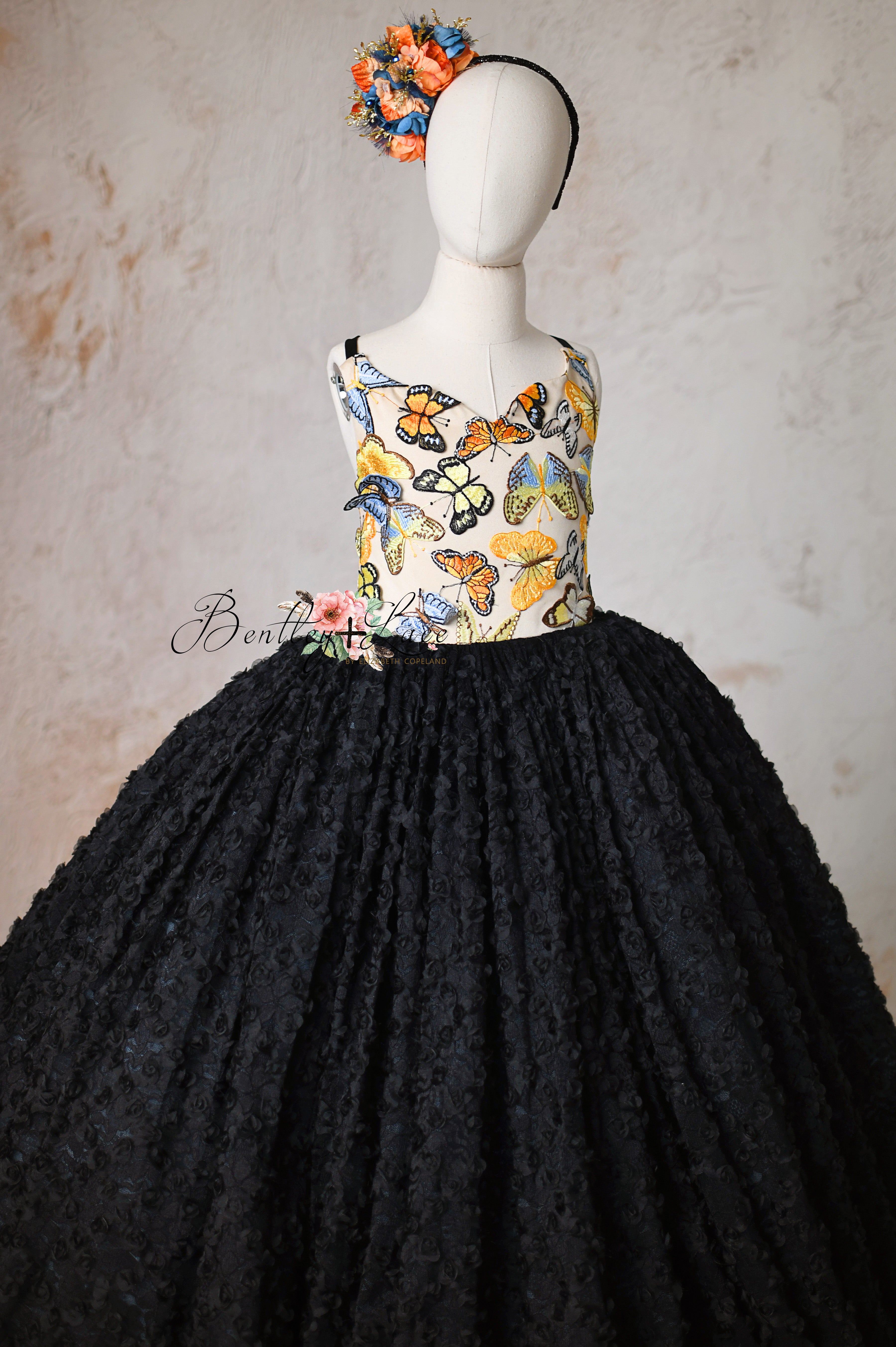 Whimsical butterfly gown for girls aged 8-10 with a dramatic, elegant flair.