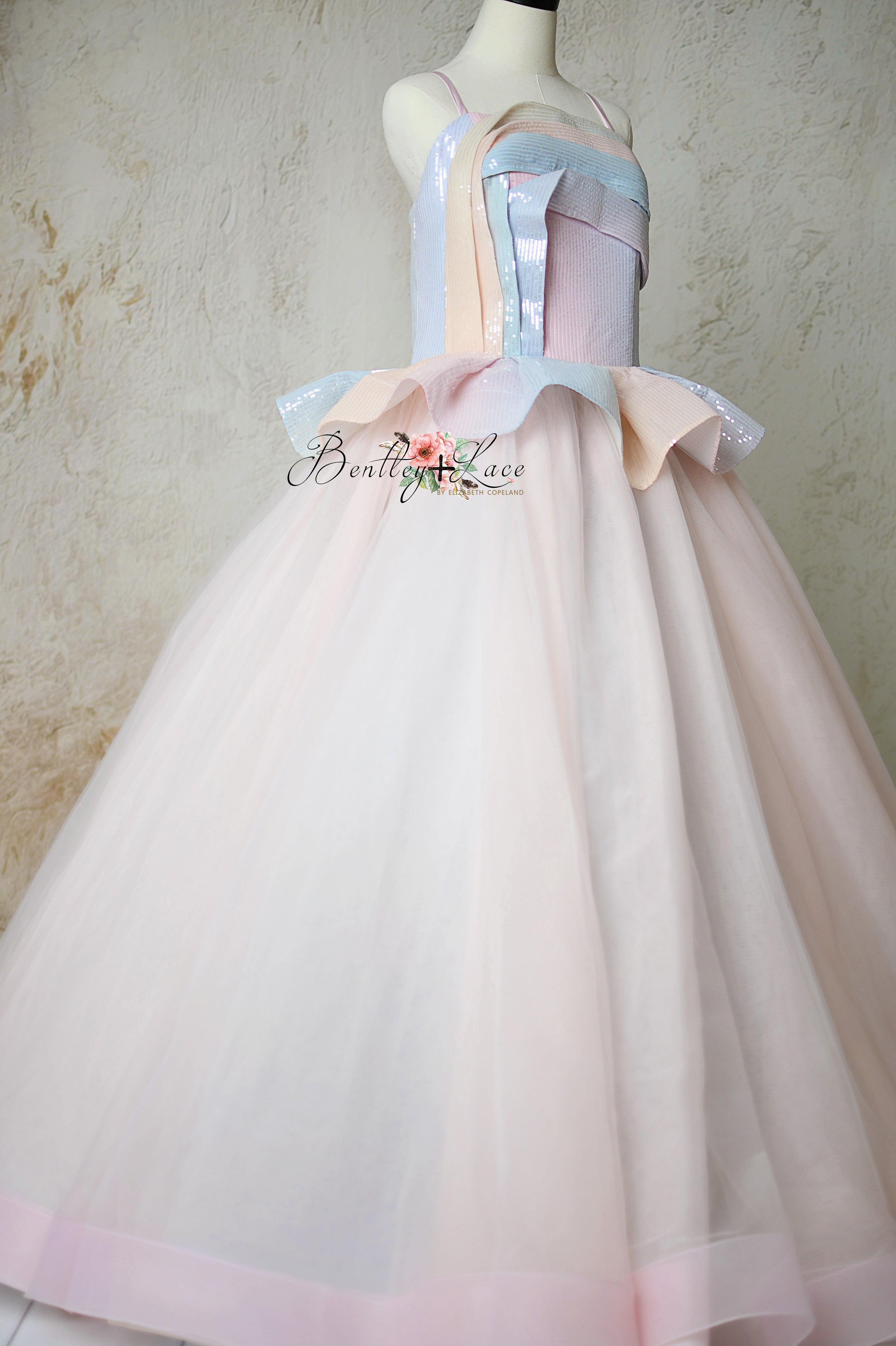 Prism of Dreams Rainbow Gown featuring a sequin peplum bodice, ombre pastel tulle skirt, and corseted back, perfect for photography events and special occasions.