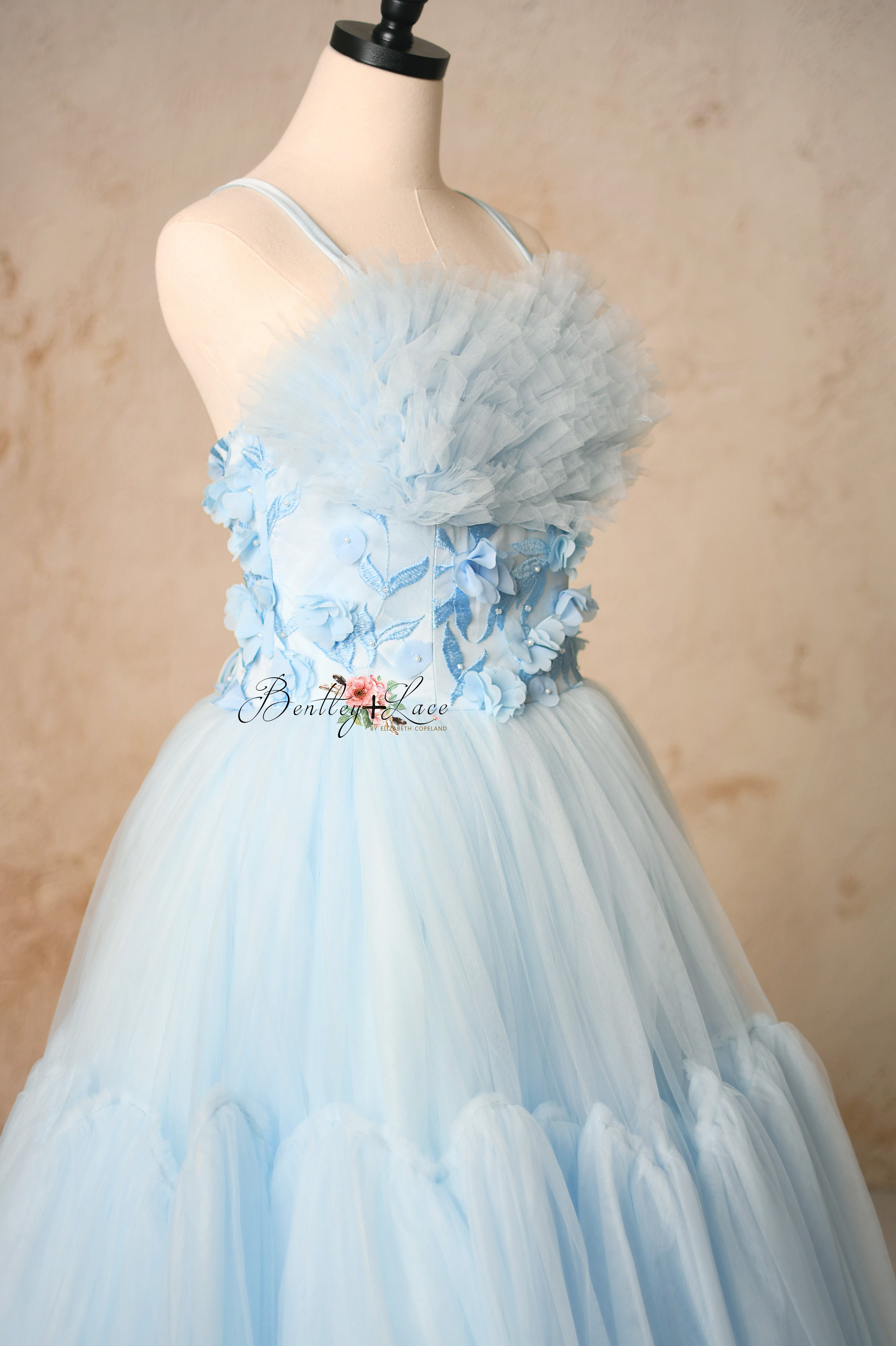 Close-up of the bodice on the Heavenly gown, highlighting intricate detailing and adjustable shoulder ties.