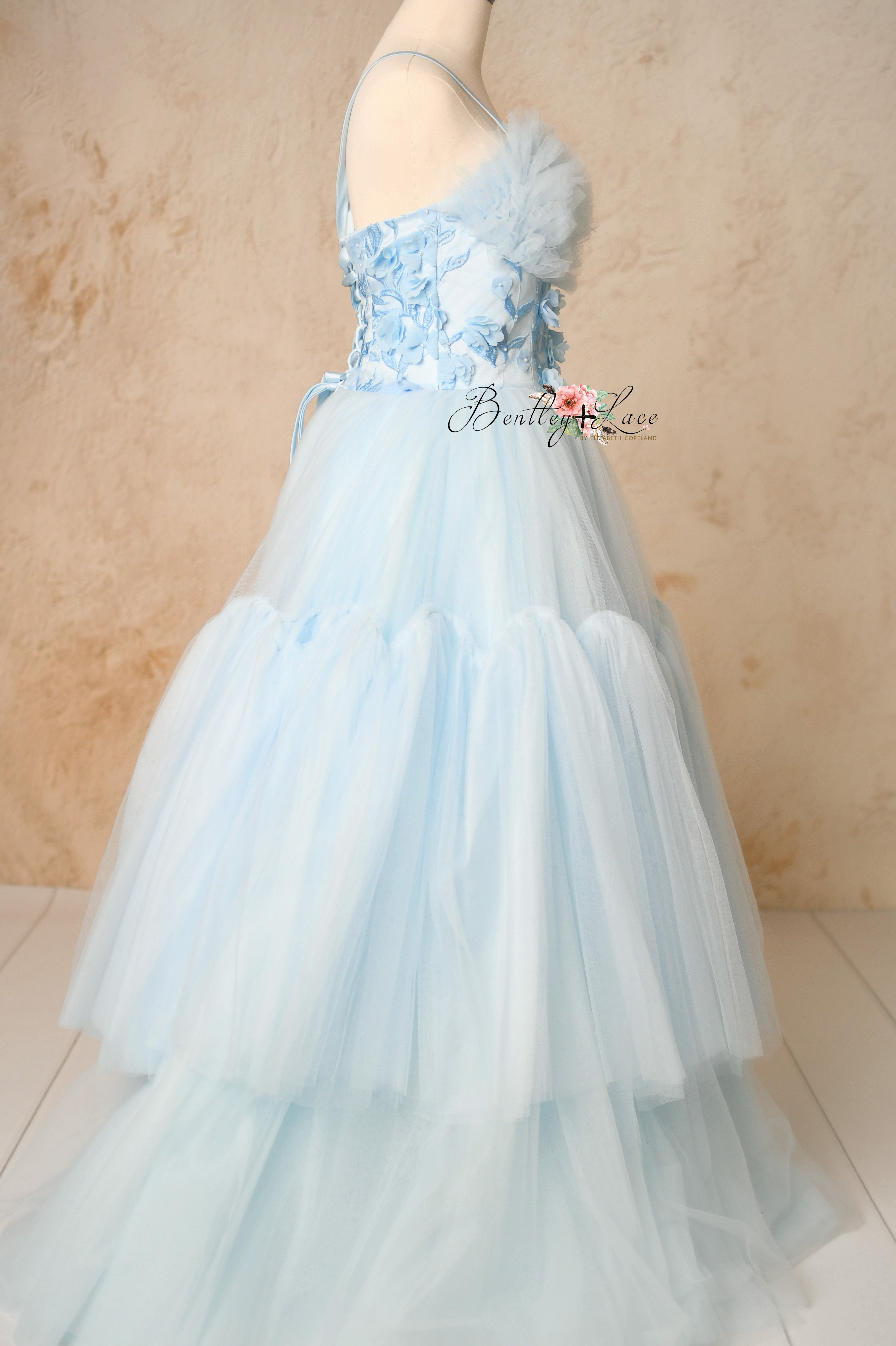 Side view of the Heavenly gown showcasing its soft, cascading tulle skirt.