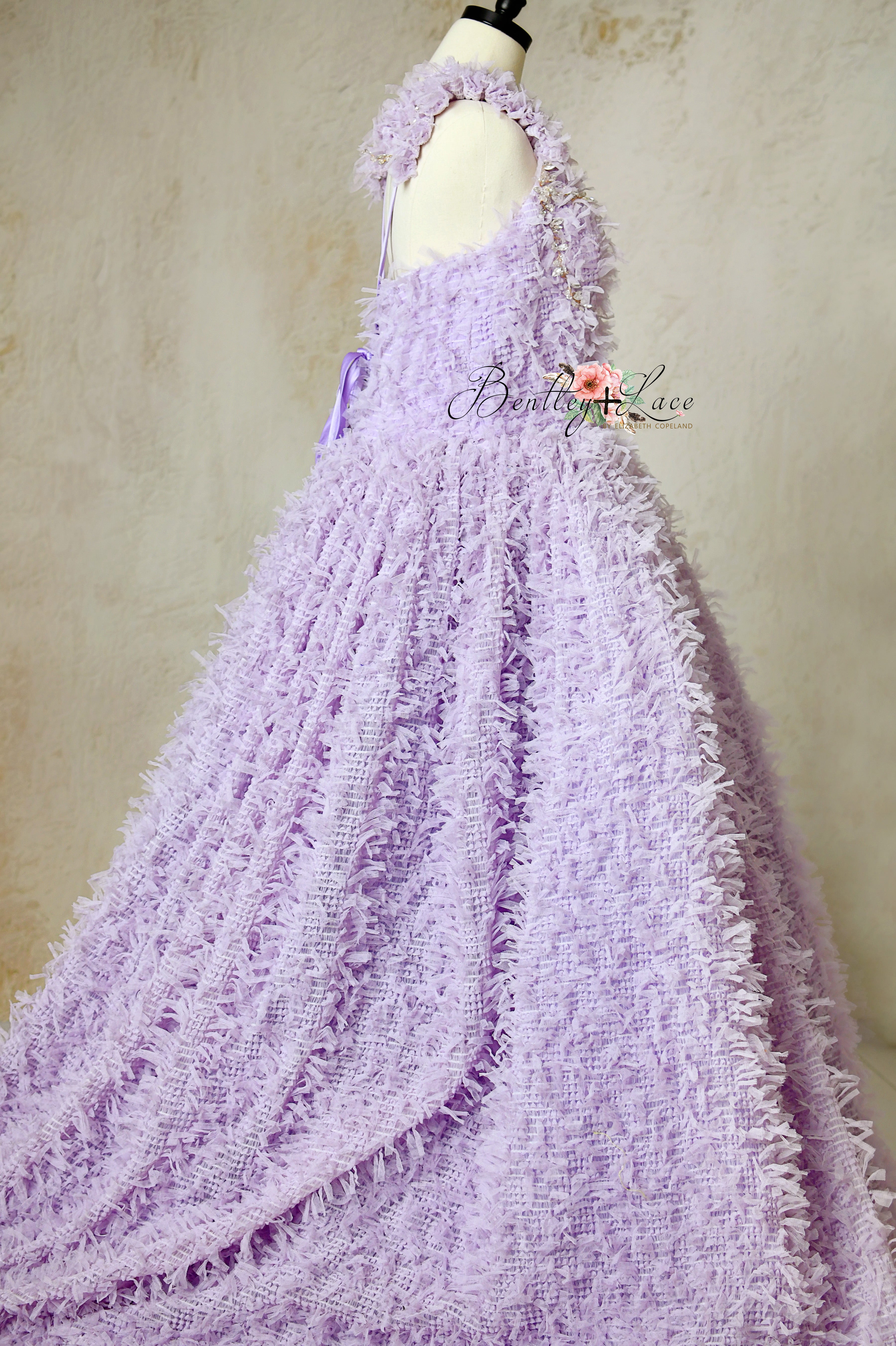 Aurelia’s Dream Lavender floor-length gown with ruffled fabric and corseted back.