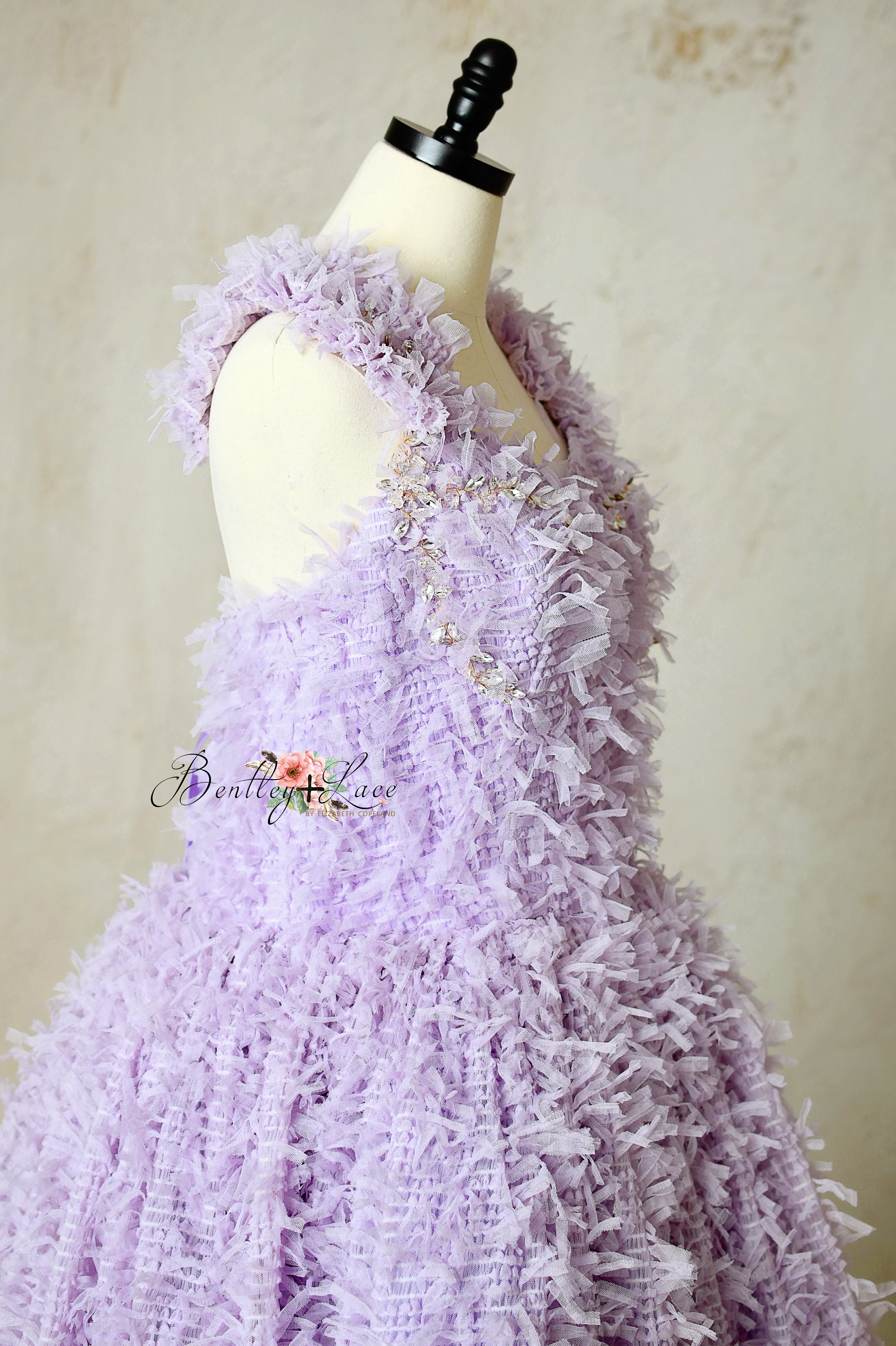 Zoomed-in shot of embroidery and mesh textures along the bodice.