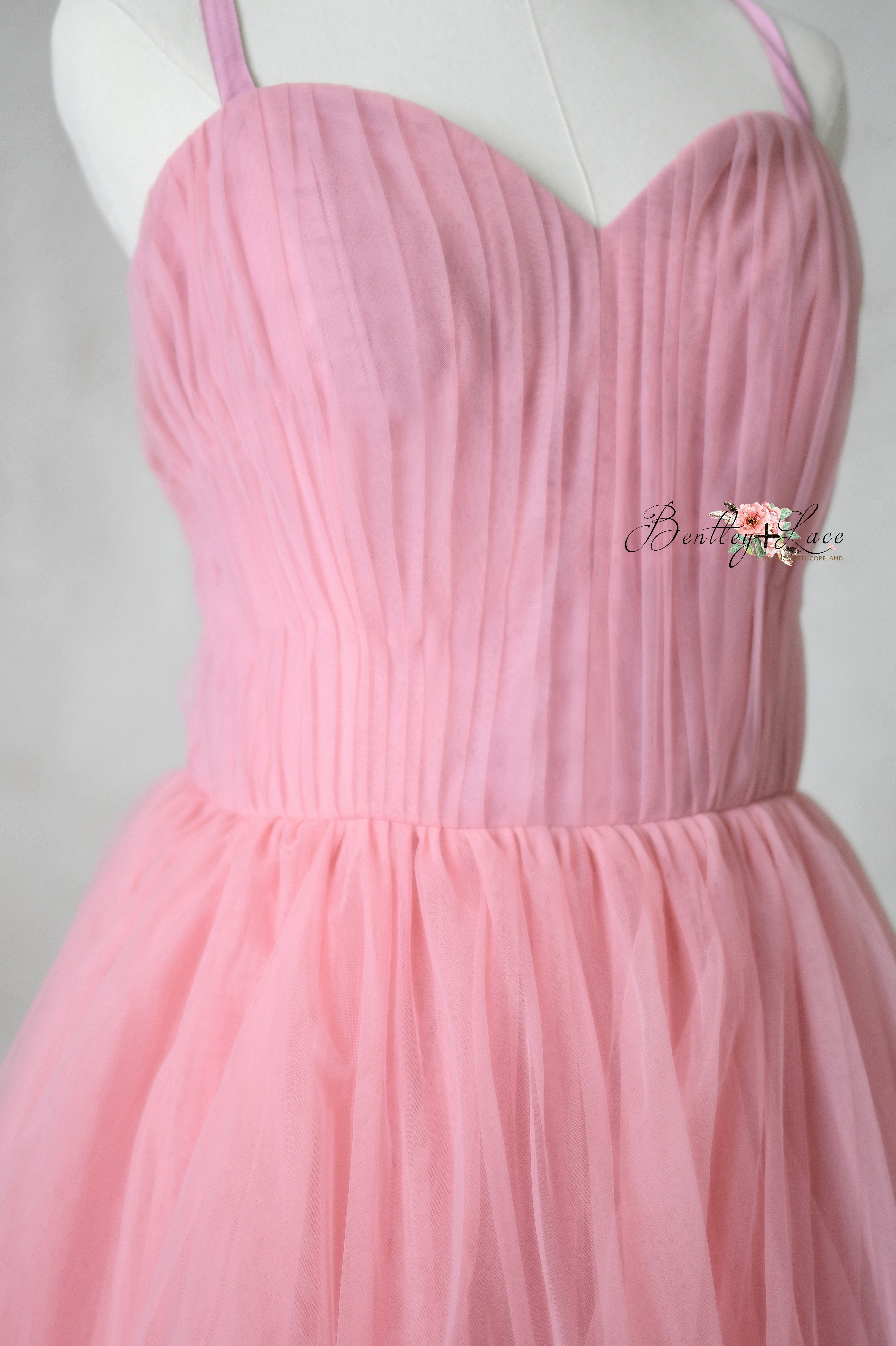 Dreamy pink tulle layers of the Rosewater Radiance gown, evoking a blossoming garden.