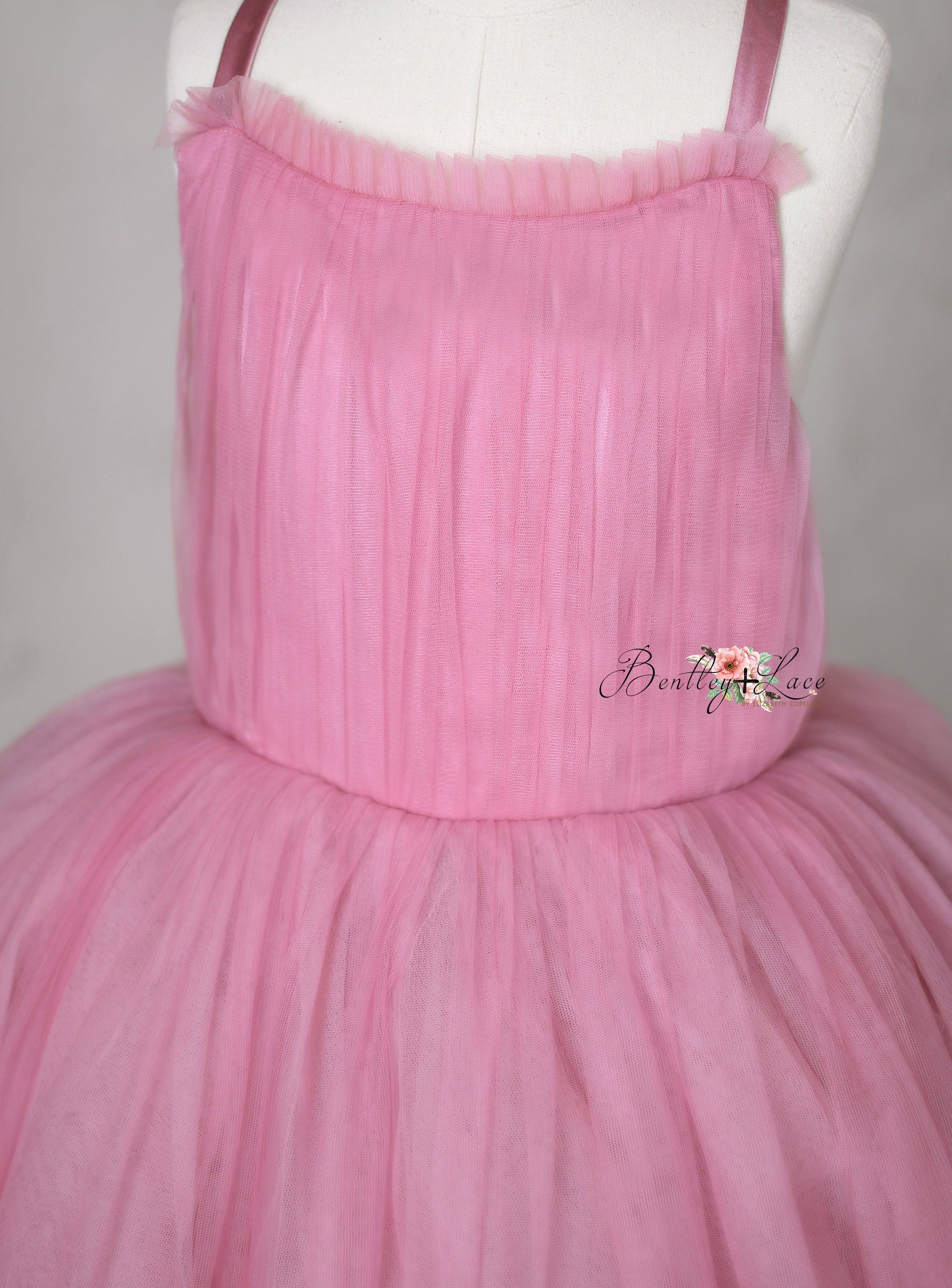 The Bows of Grace floor-length gown featuring intricate hand-sewn bows and satin accents, perfect for special occasions.