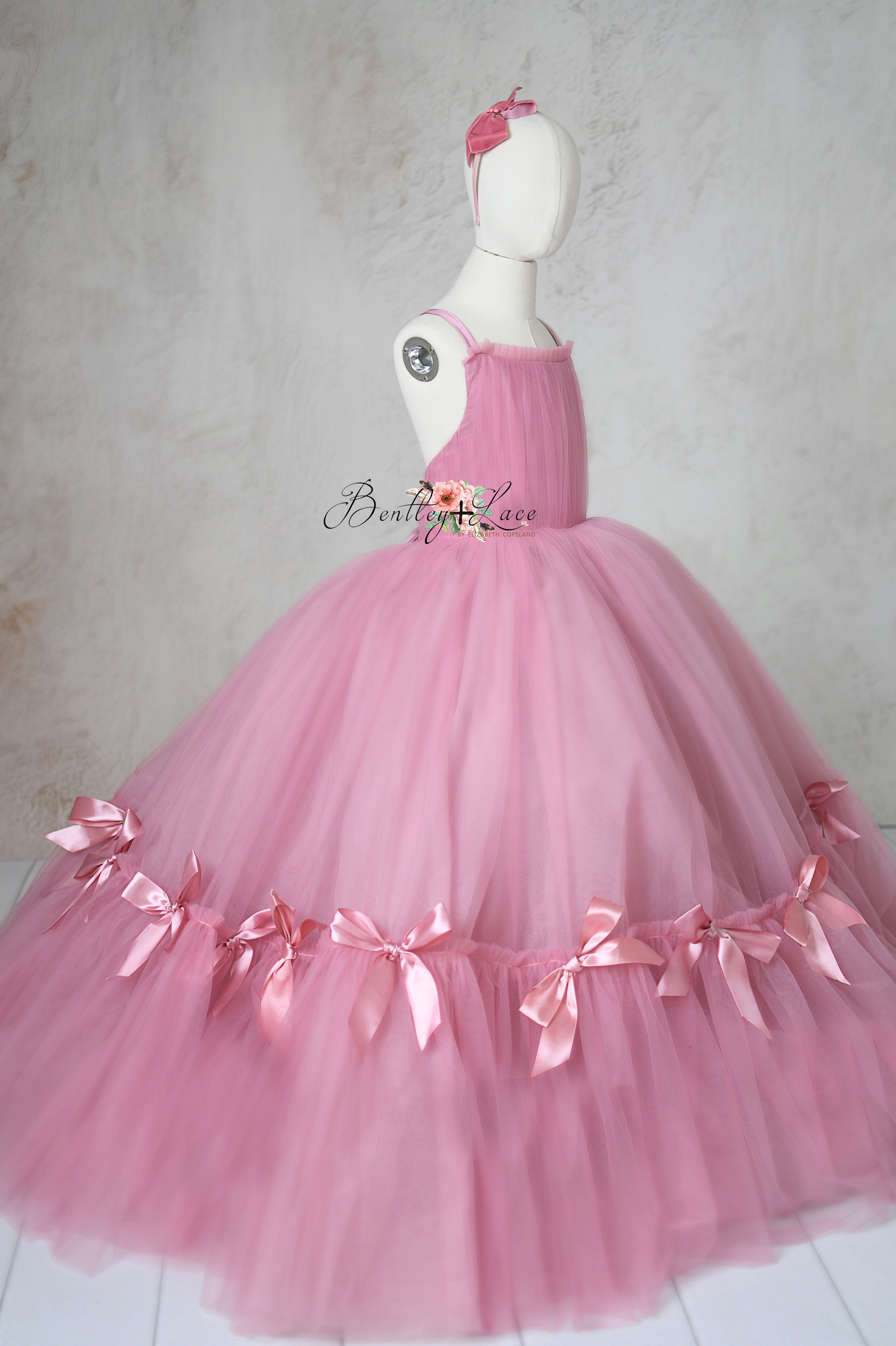 The luxurious bridal soft tulle of the Bows of Grace gown shimmering as the model moves.