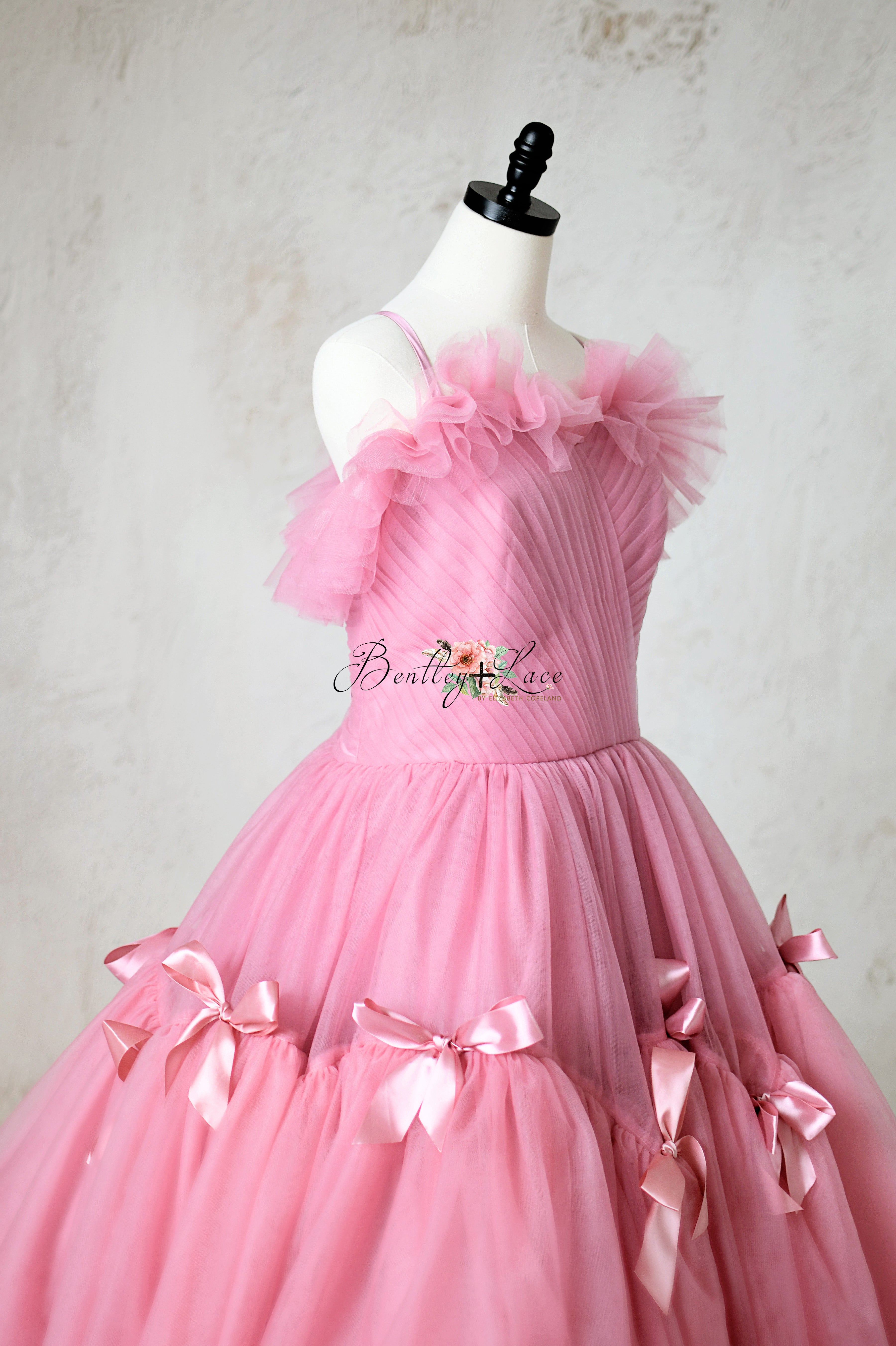 Stunning pink dress with a structured bodice and voluminous tulle skirt.